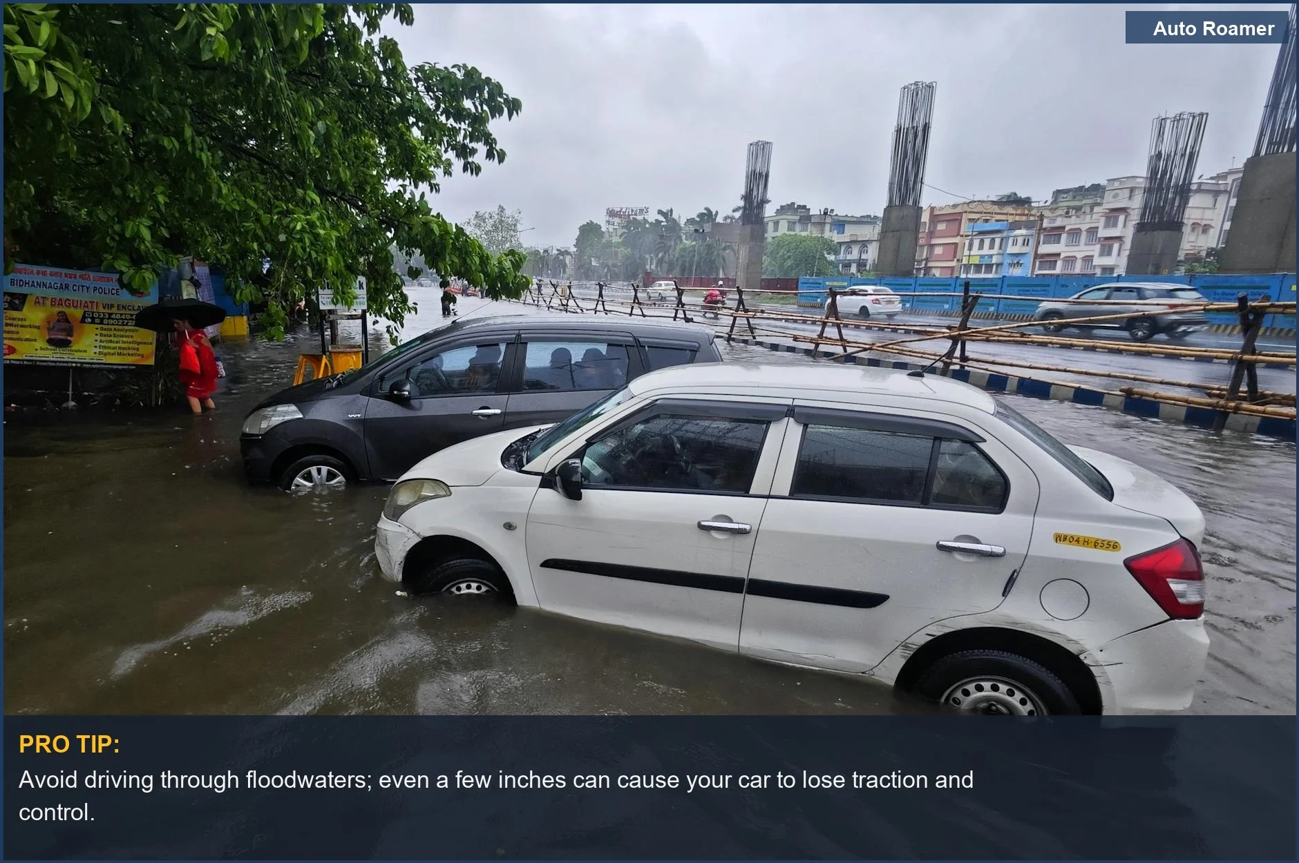 Multiple vehicles submerged in floodwaters on a street during heavy monsoon rainfall in an Indian city.
