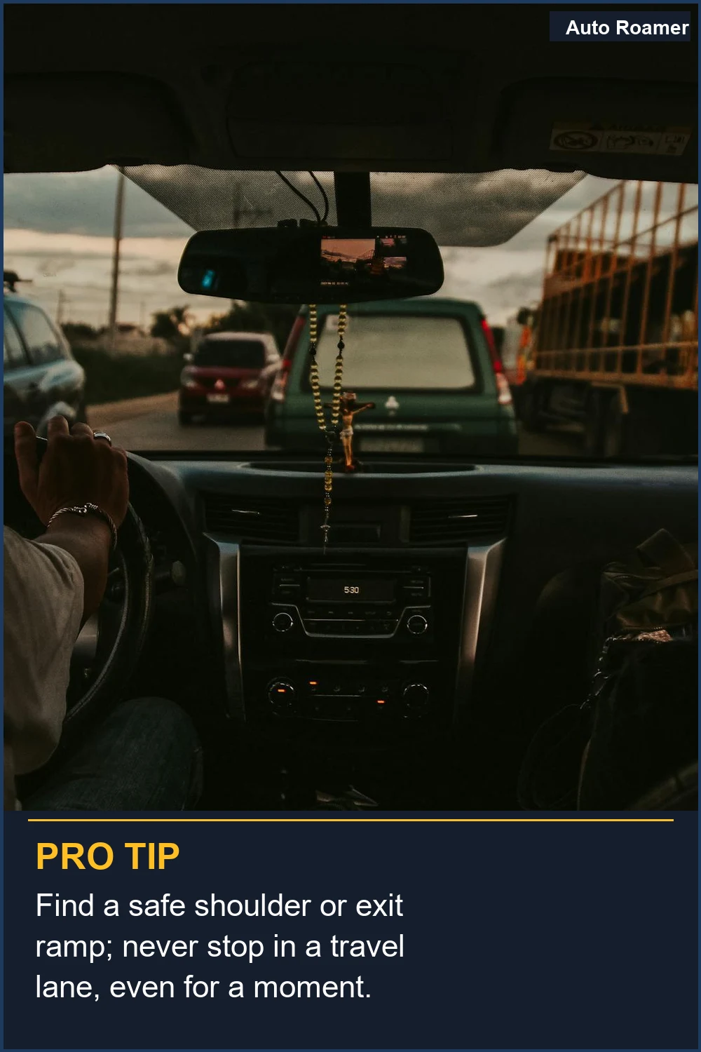 Find a safe shoulder or exit ramp; never stop in a travel lane, even for a moment.