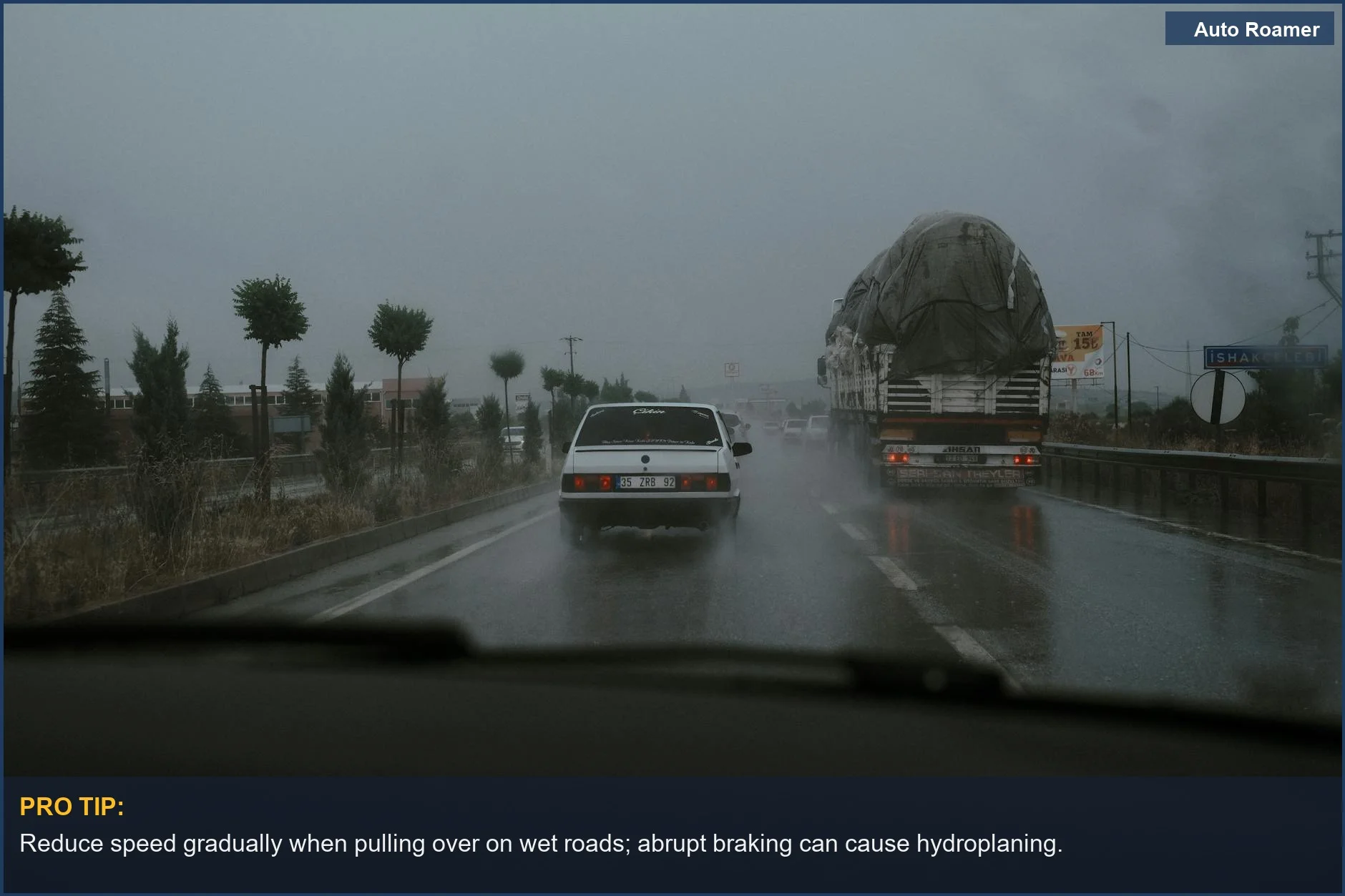 Vehicles driving on a wet highway during rainfall, highlighting highway pullover safety challenges.