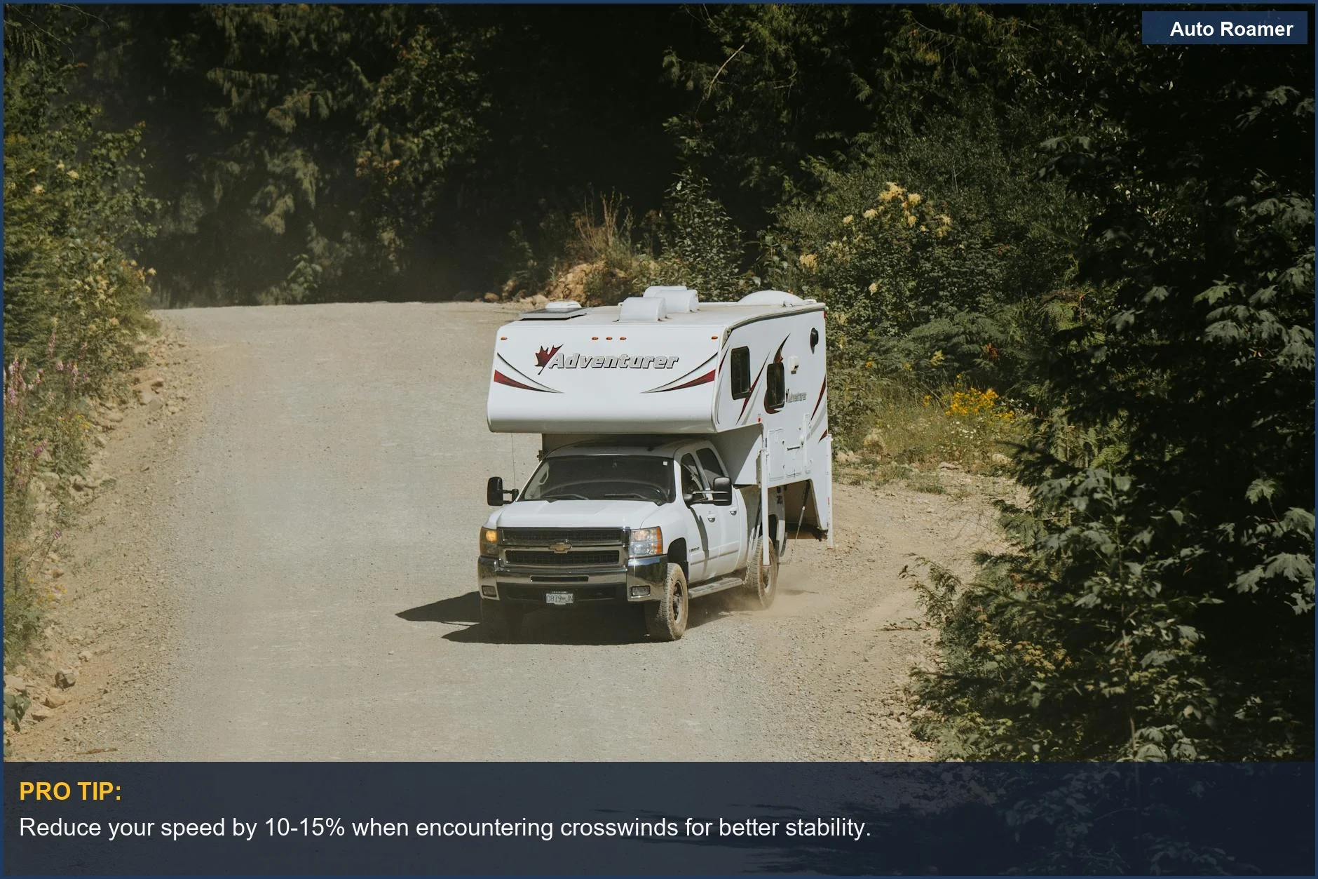White camper truck on a winding dirt road, illustrating safe trailer towing in challenging conditions.
