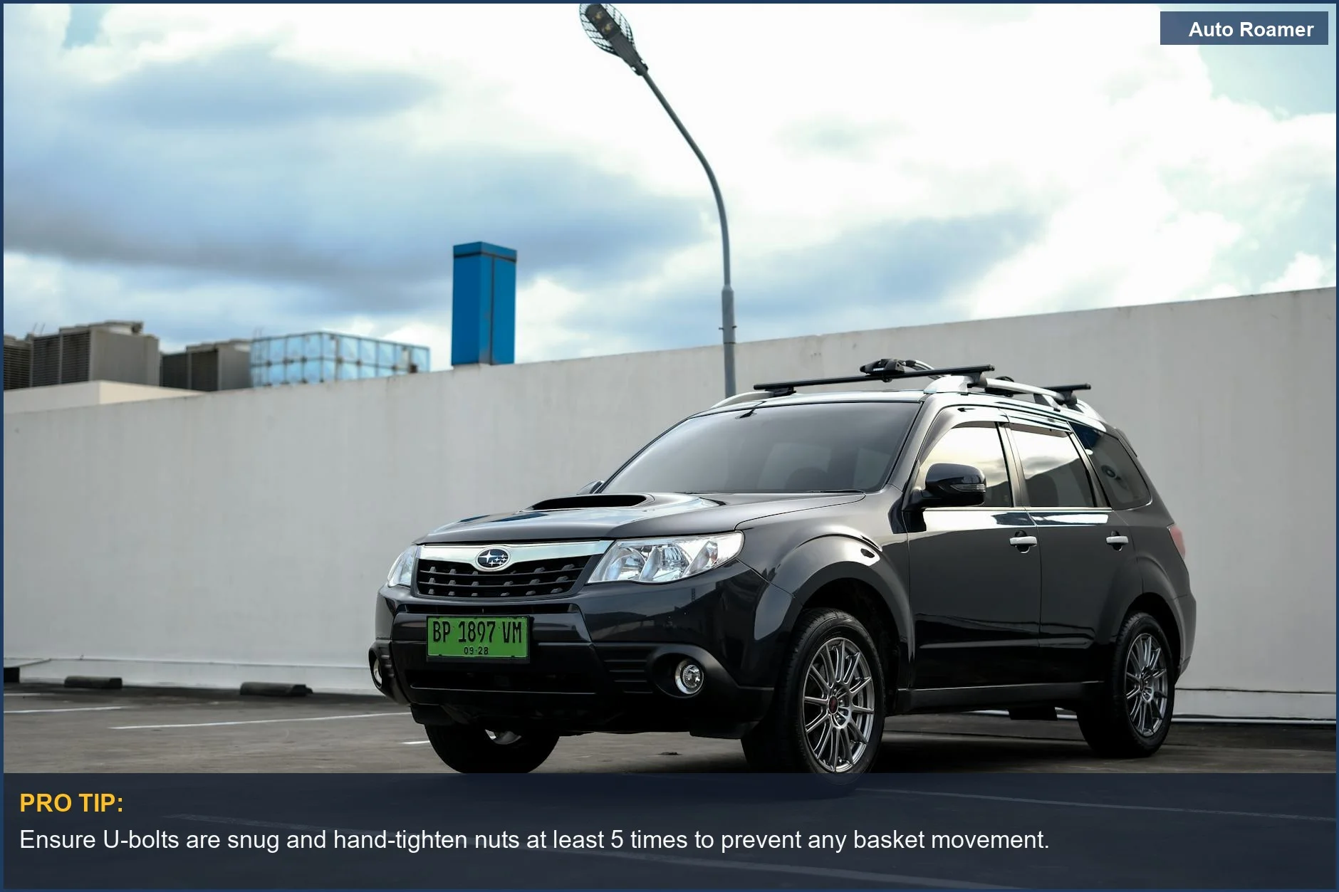 Securely mount rooftop cargo basket to a black Subaru Forester with U-bolts and brackets for car roof rack mounting.