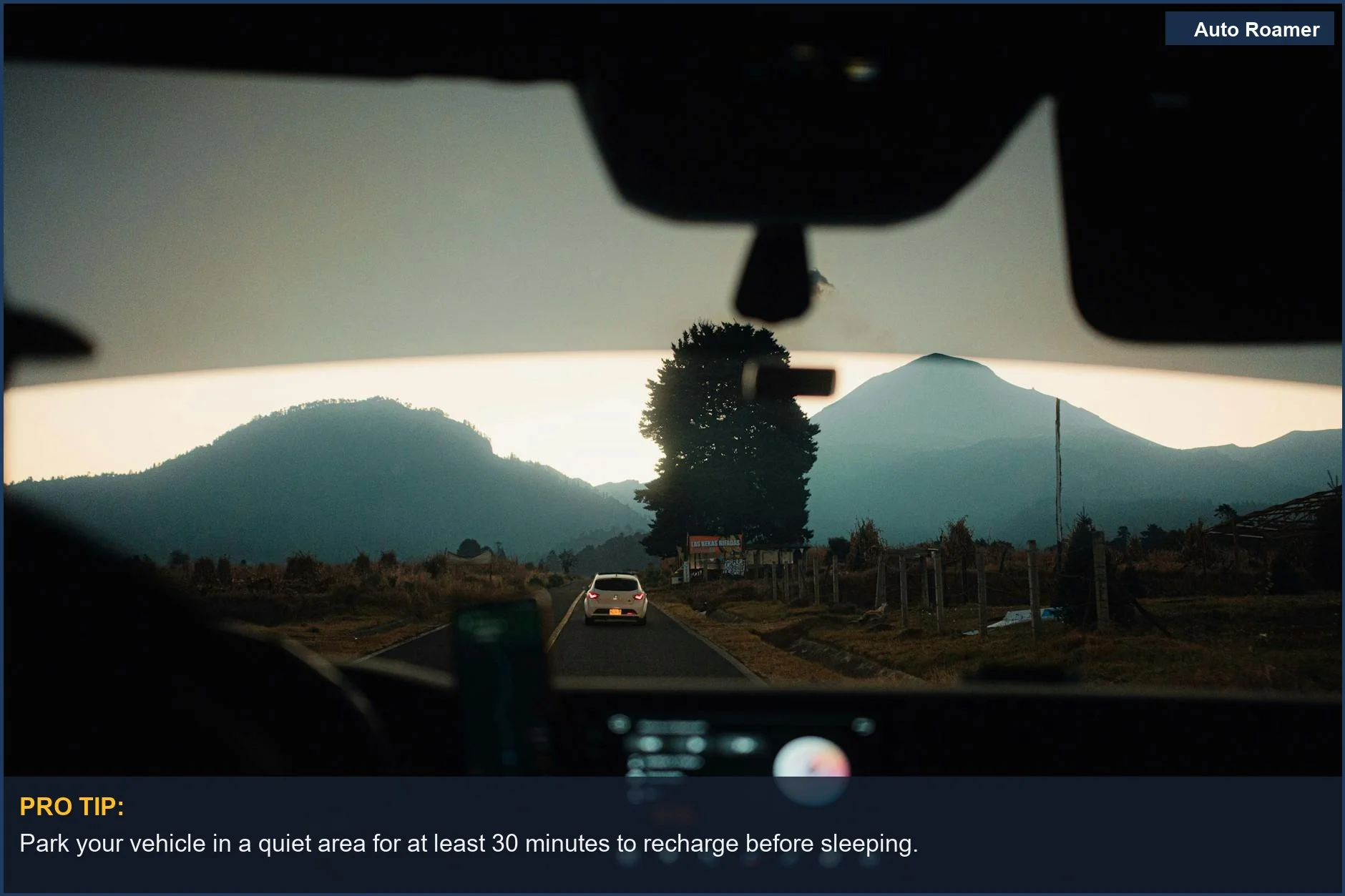Scenic view from a car driving on a mountain road during sunset, ideal for restful stops.