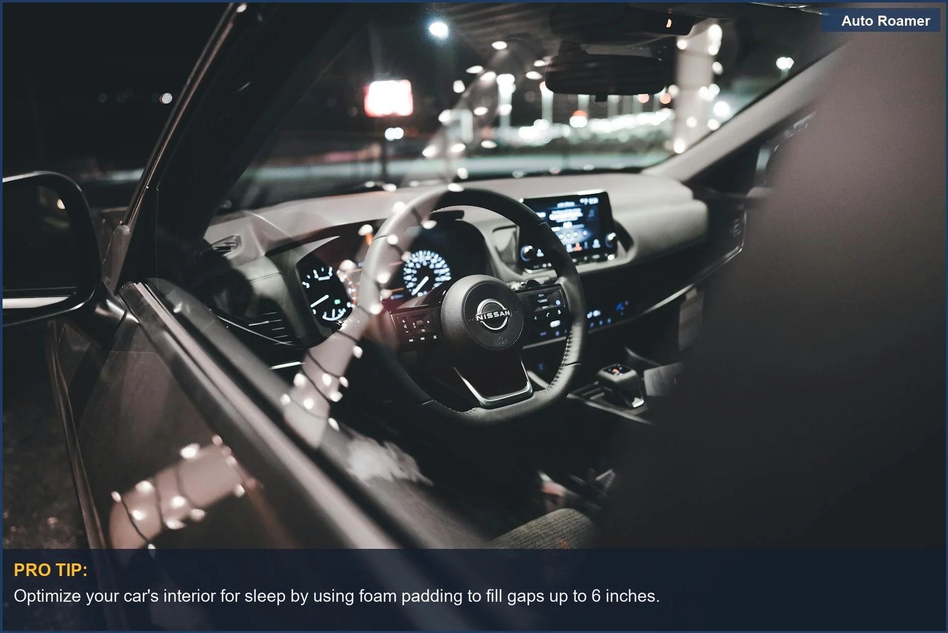 Illuminated car dashboard and steering wheel inside a Nissan, highlighting the importance of vehicle comfort for sleeping.