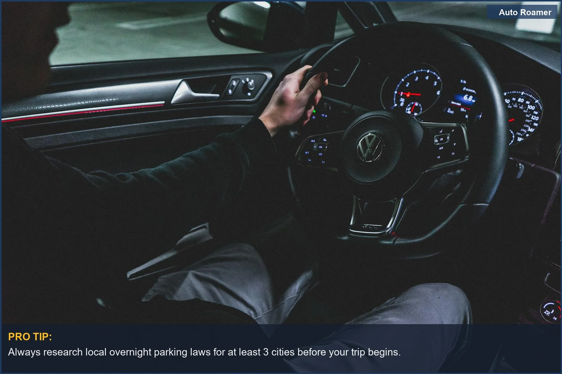Driving a modern Volkswagen at night, dashboard lit, emphasizing researching local laws for legal car sleeping.