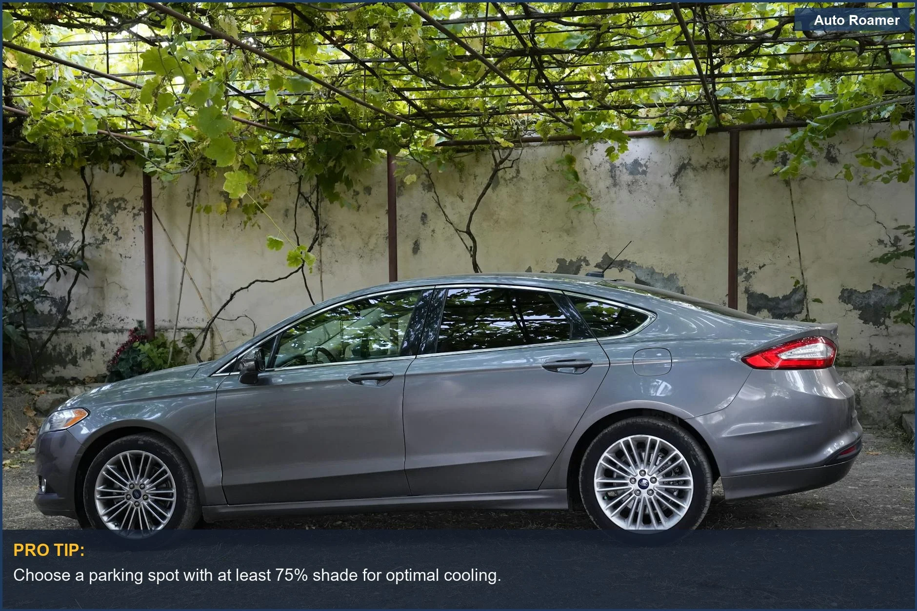 Side view of a silver sedan parked under a pergola surrounded by lush greenery, offering a shaded spot.
