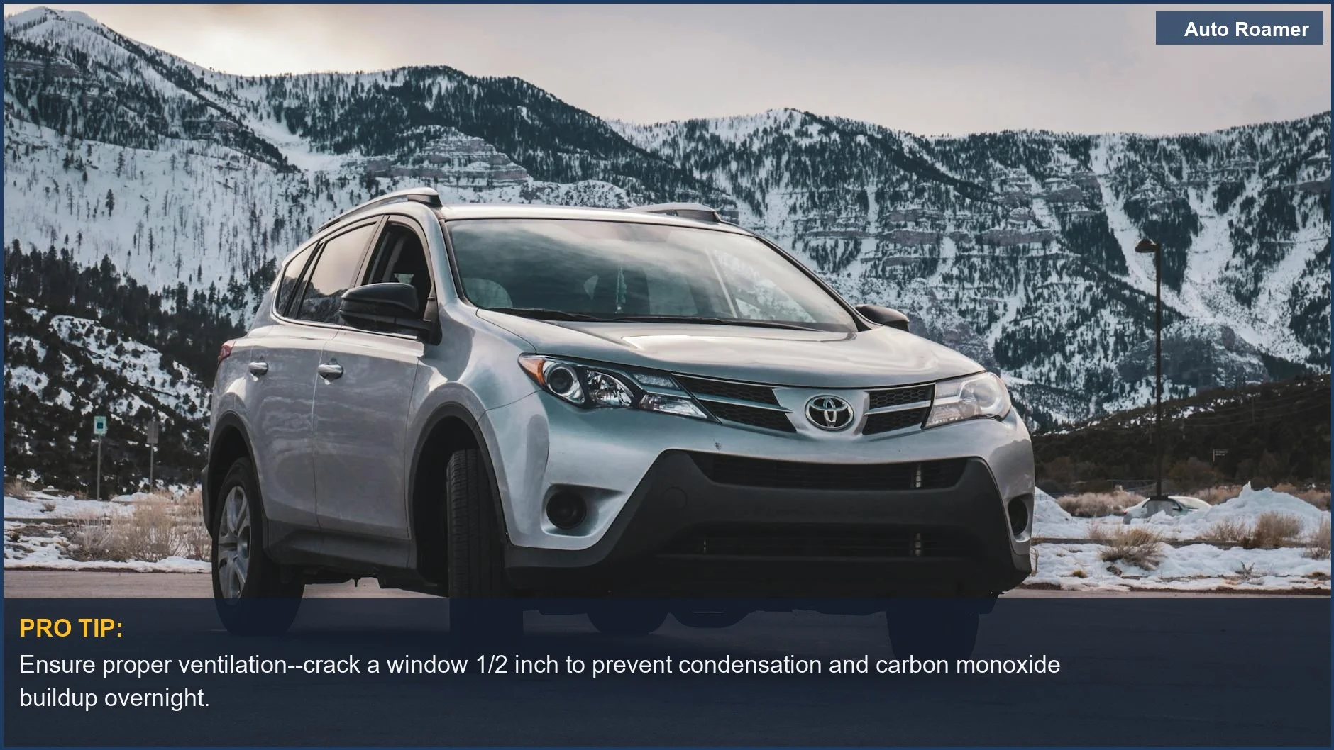 A silver SUV parked against a breathtaking backdrop of snowy mountains, offering car camping in winter tips for safety.