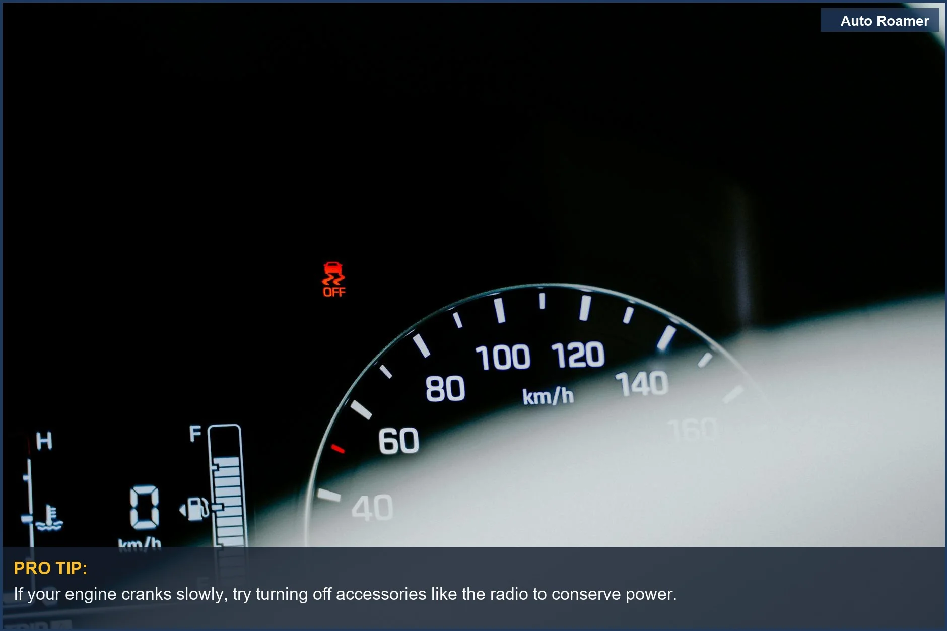 Close-up of a car speedometer showing warning lights and digital readings for battery issues.