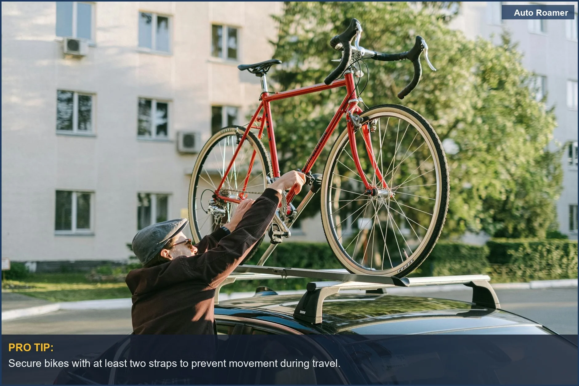 Man securing a red bicycle on an SUV roof rack in the city, demonstrating how to use an SUV roof rack.