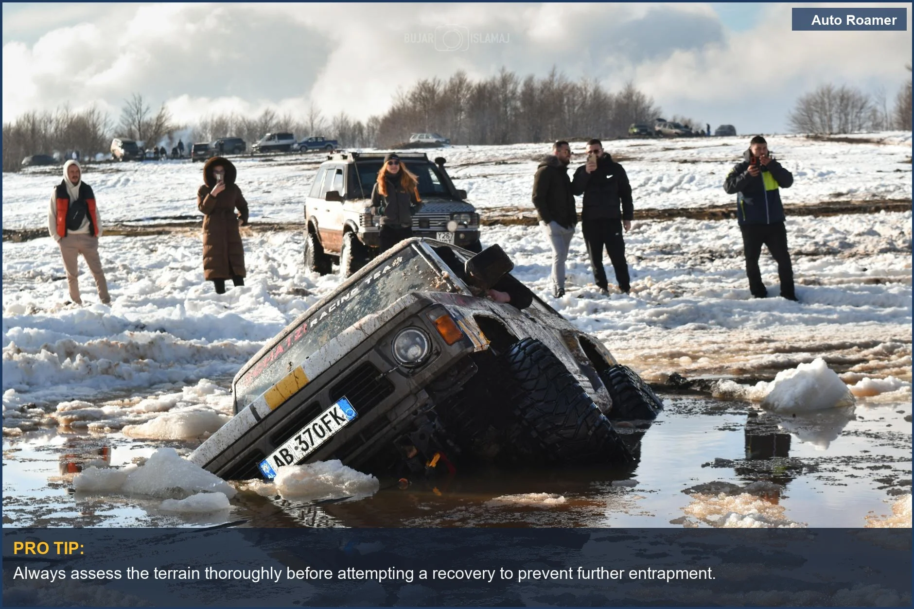 Off-road SUV stuck in deep mud and snow, illustrating the challenge of off-road recovery techniques.