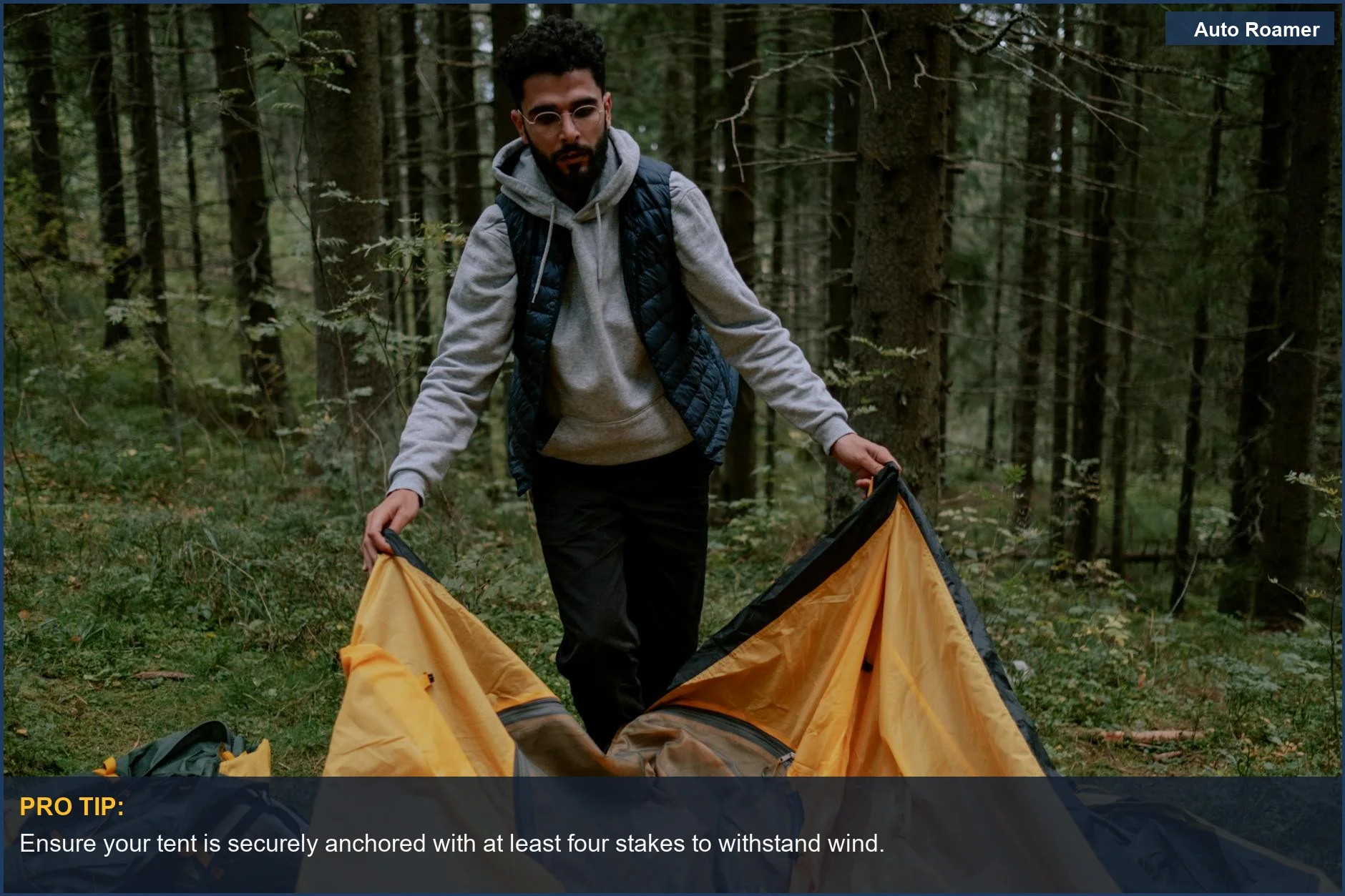 Man sets up a bright yellow tent in the forest, demonstrating practical Hyundai camping accessories usage
