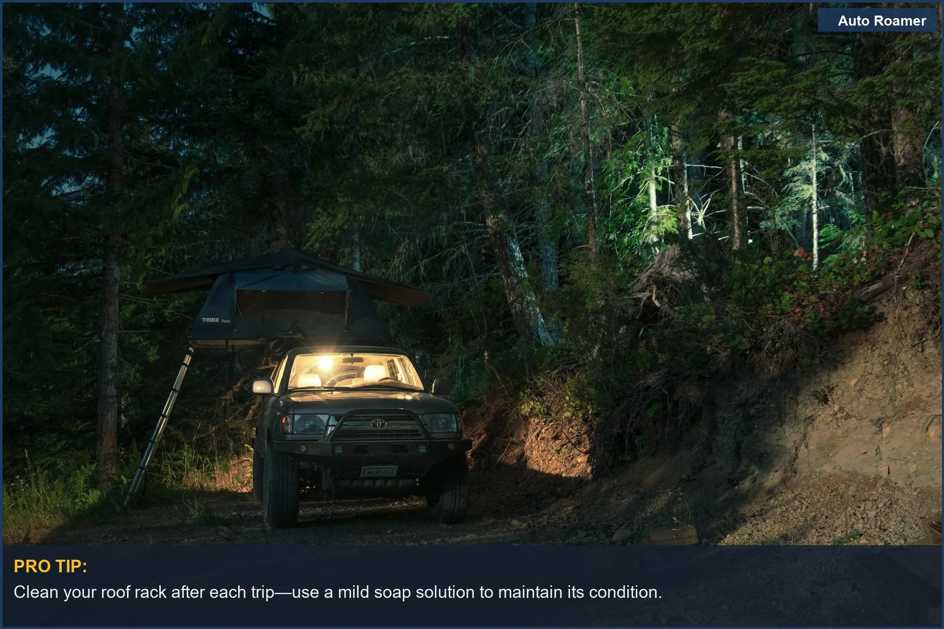 SUV with rooftop tent parked in dimly lit forest campsite at night.