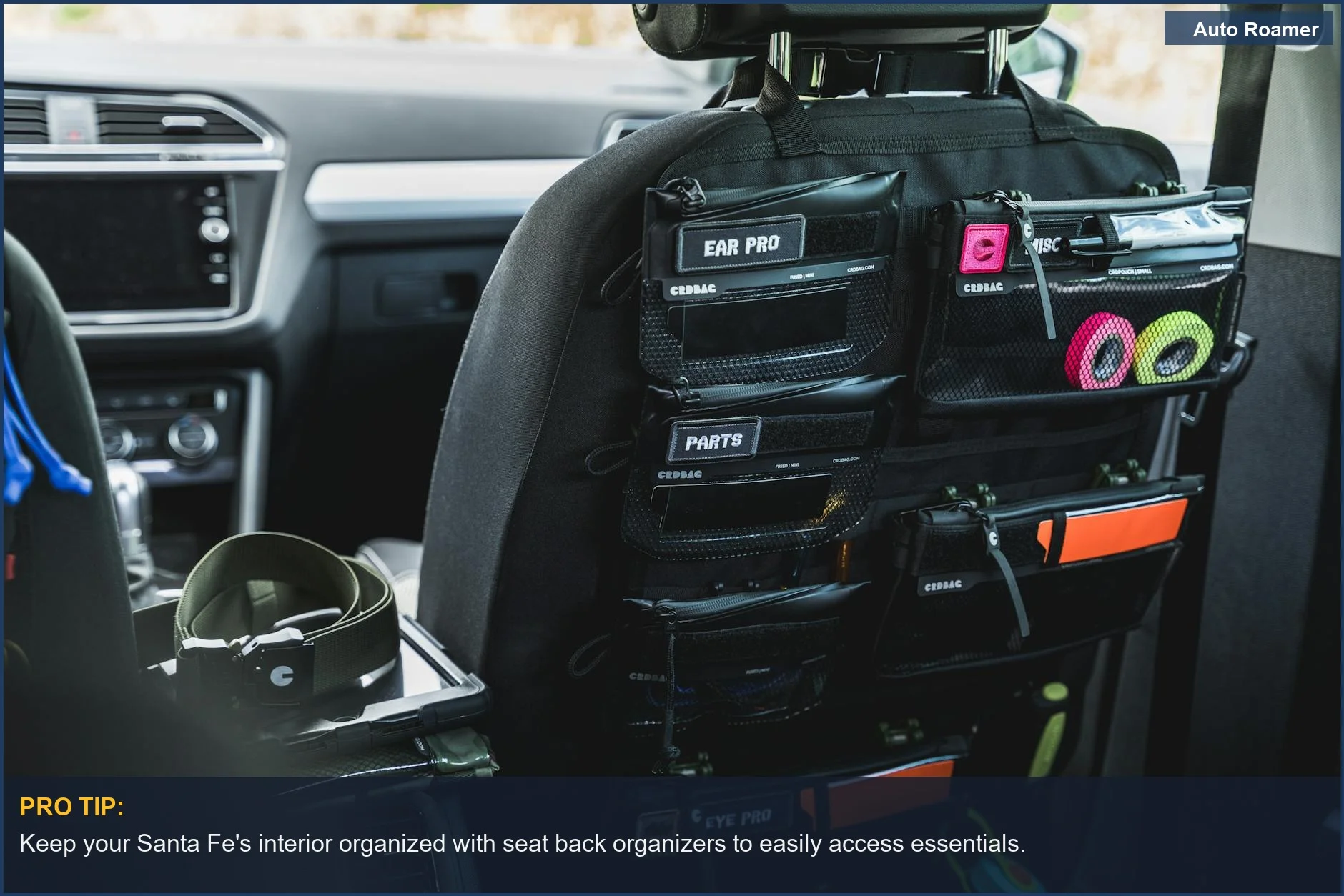 Car seat back organizer with labeled pockets for accessories on a Hyundai Santa Fe interior.