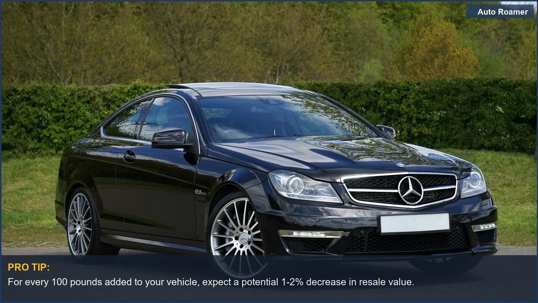 Lujoso cupé Mercedes negro en un entorno verde muestra escenarios del mundo real del impacto de los accesorios en el valor y el rendimiento del coche.