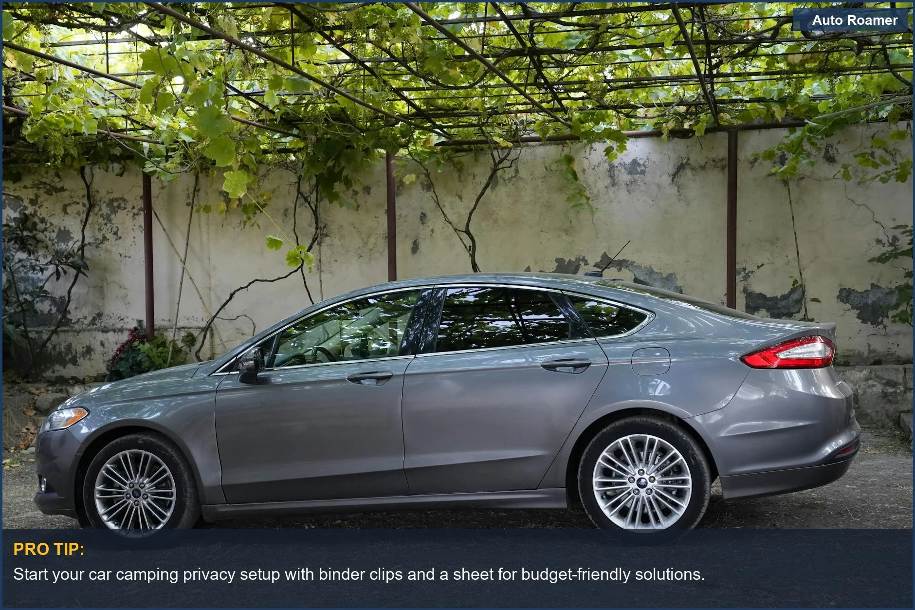 Silver sedan parked under a pergola with greenery, illustrating simple car camping privacy solutions.