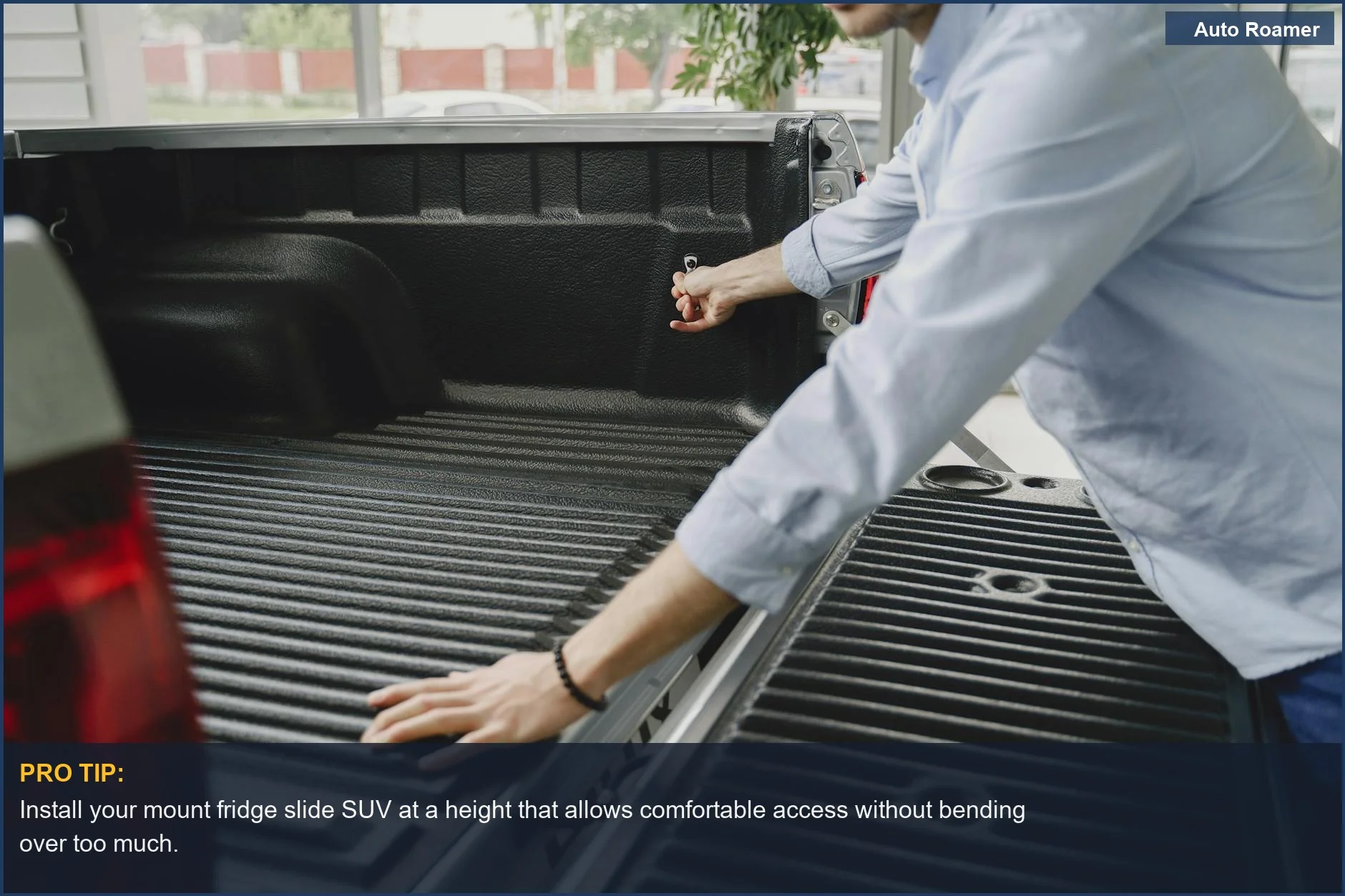 Man accessing fridge in truck bed using a slide for easy access to drinks.