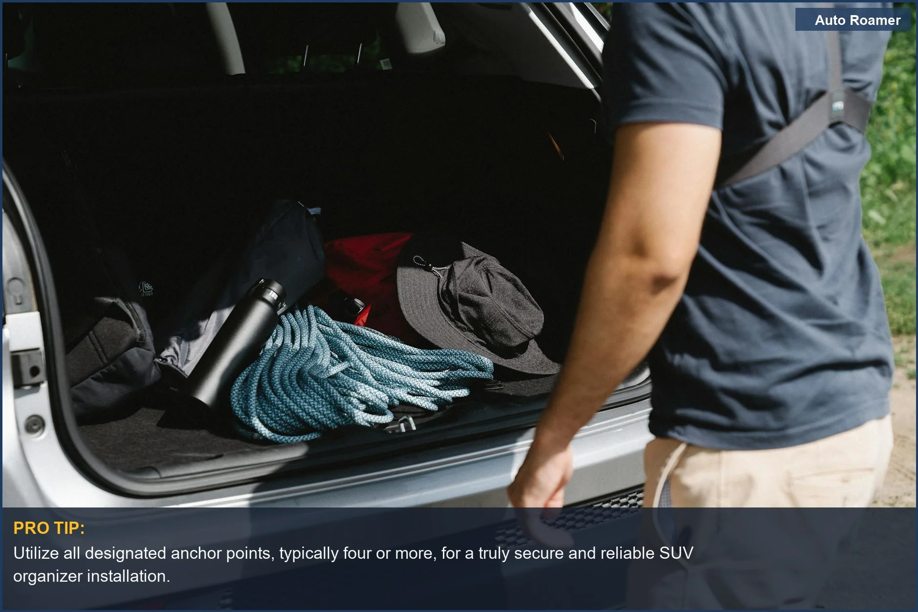 Man organizing camping gear in an SUV trunk, ready for an adventure with a net.