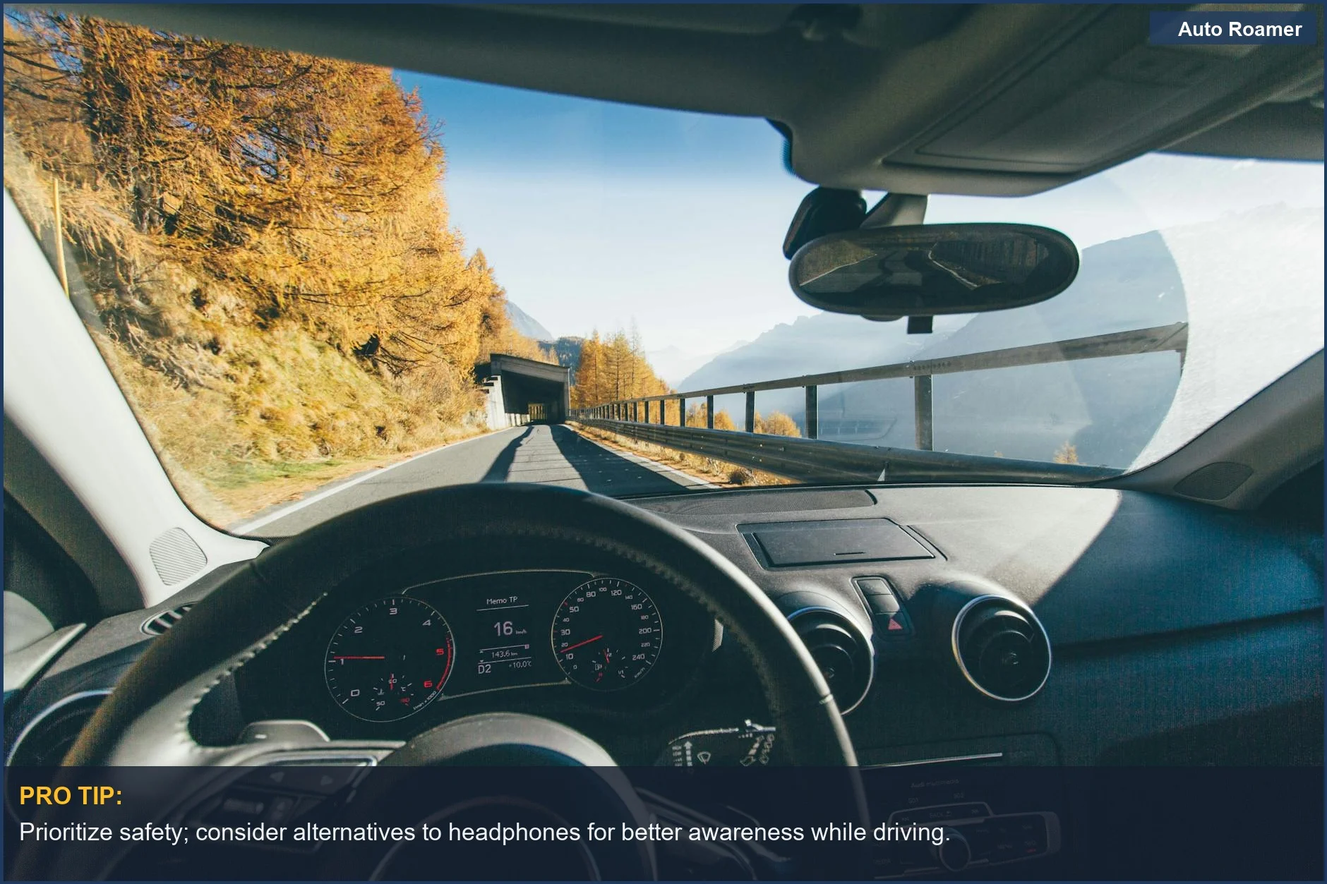 Scenic mountain road view from a car interior, inspiring thoughts on driving safety with headphones.