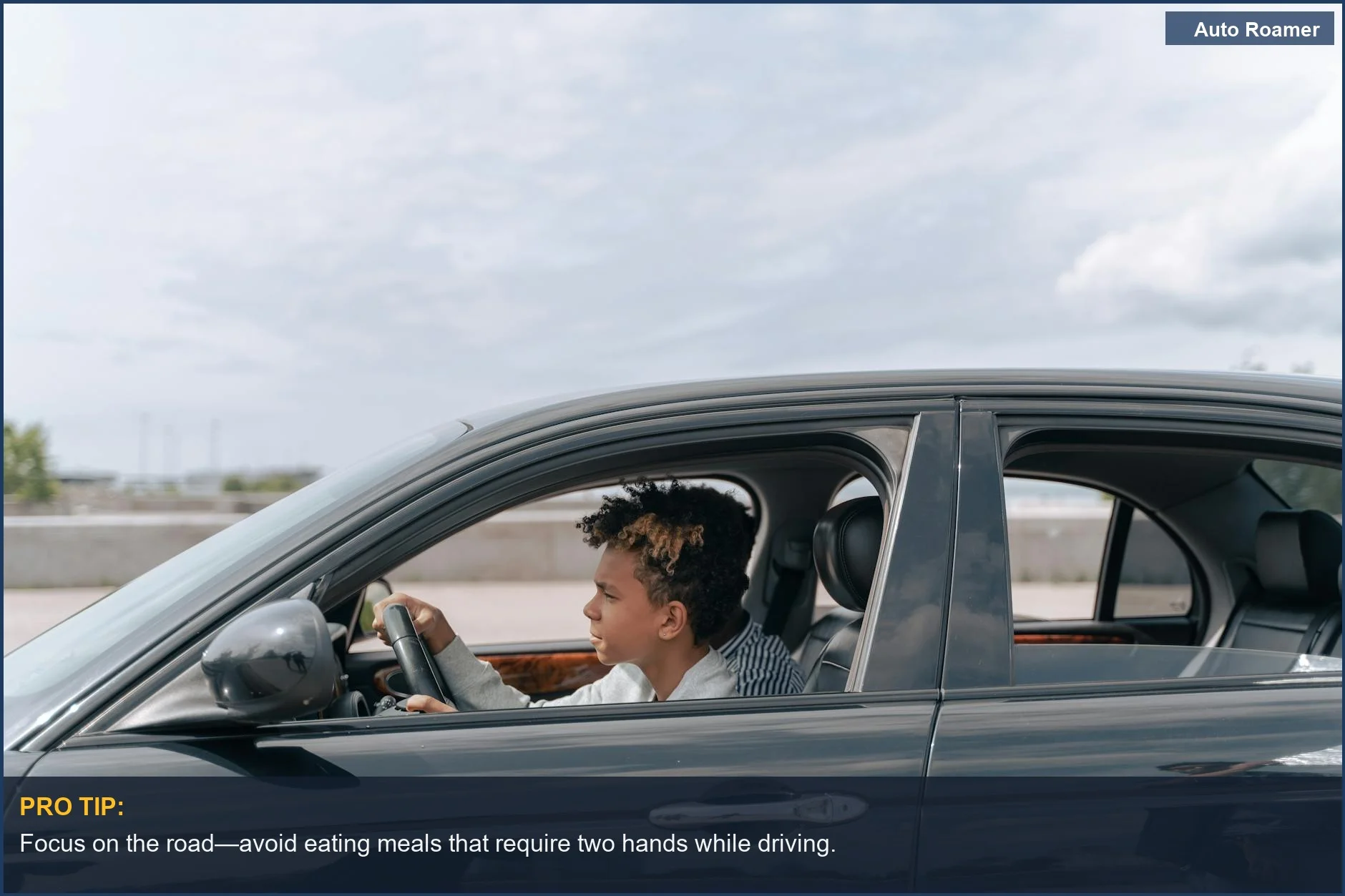 Young male teenager concentrating on driving during bright daylight, highlighting road safety.