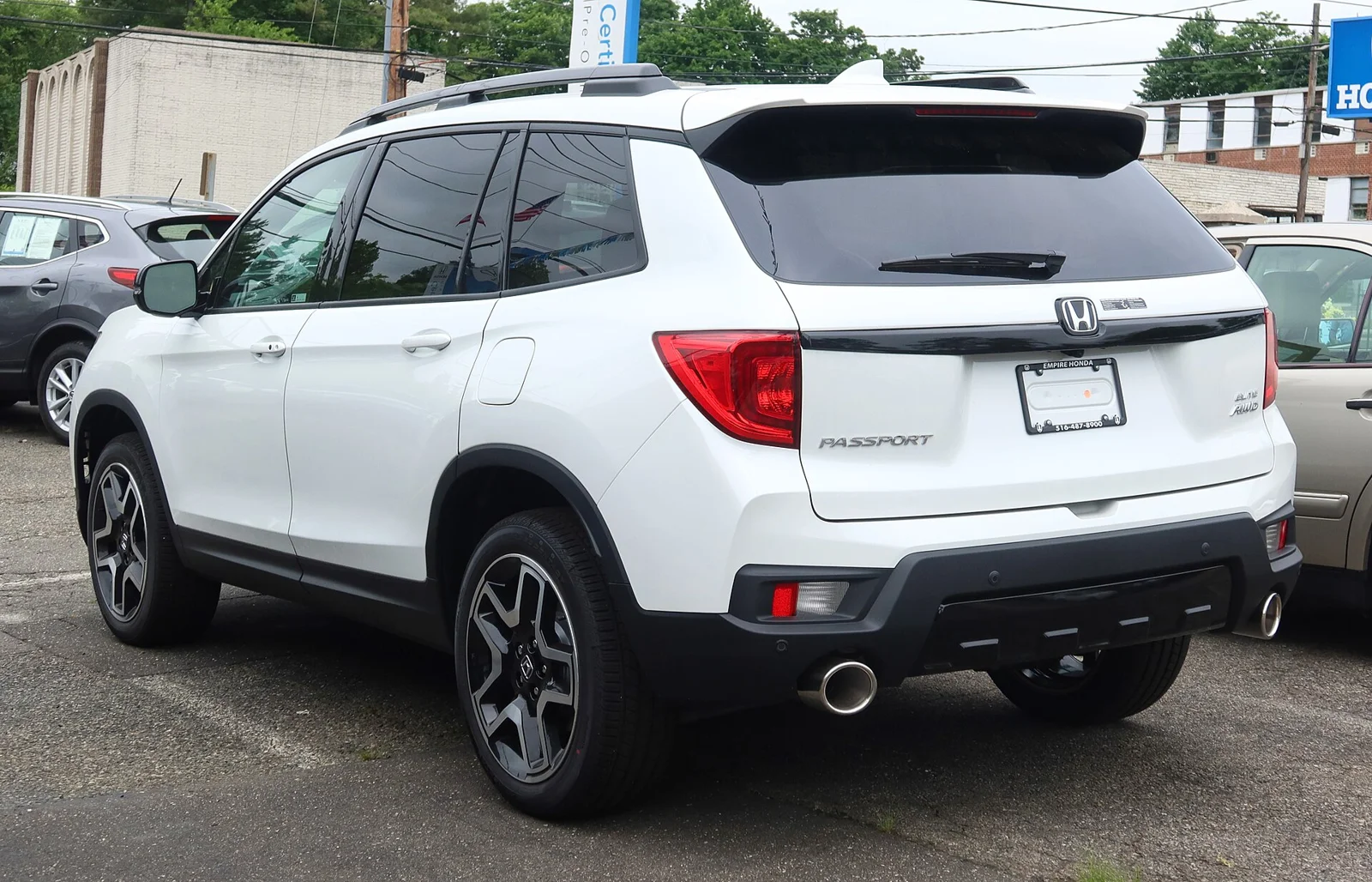White Honda Passport, current third generation, rear three-quarter view showing the tailgate and PASSPORT lettering.