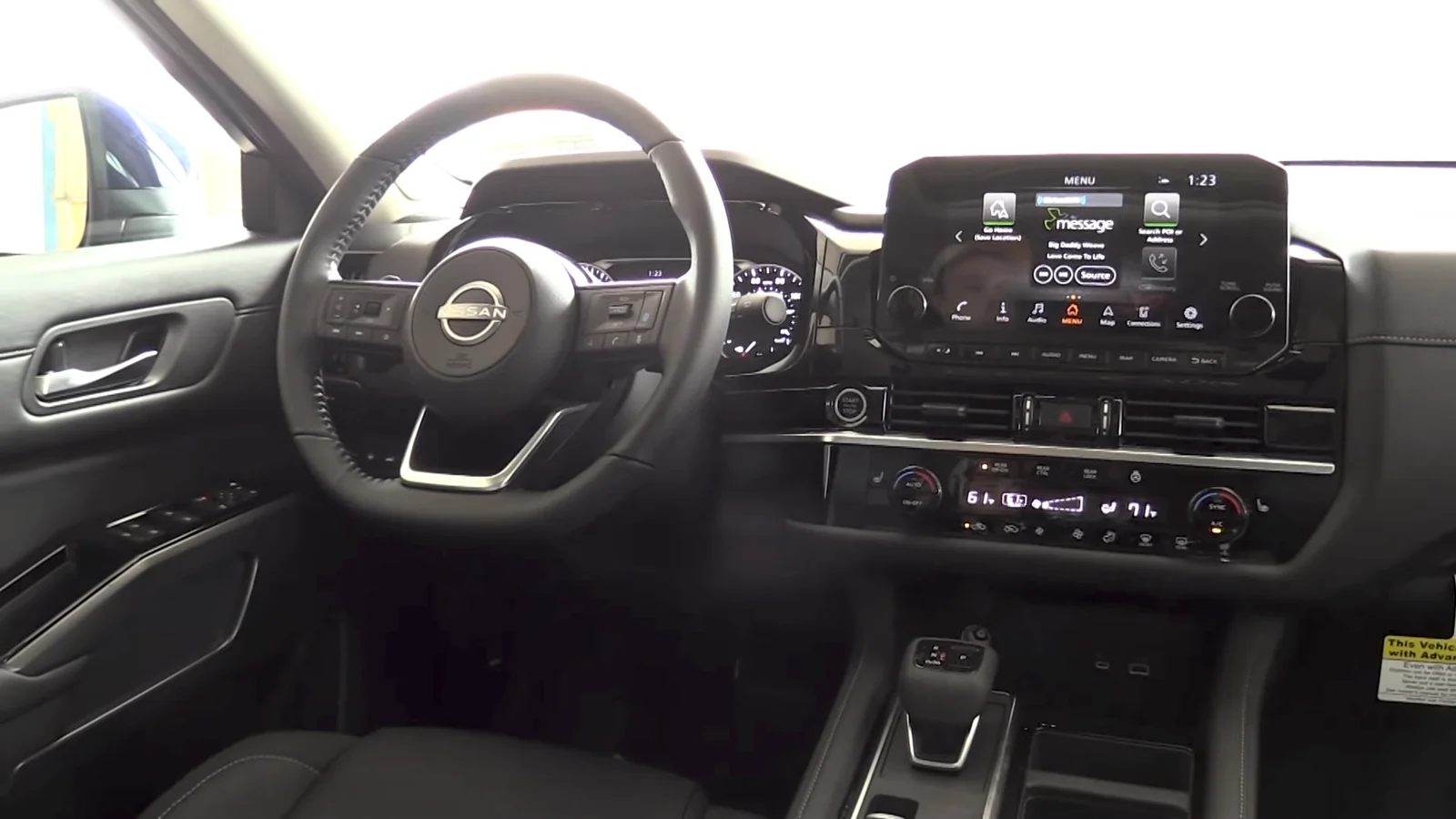The interior of a current R53 Nissan Pathfinder, showing the dashboard, steering wheel and centre touchscreen.