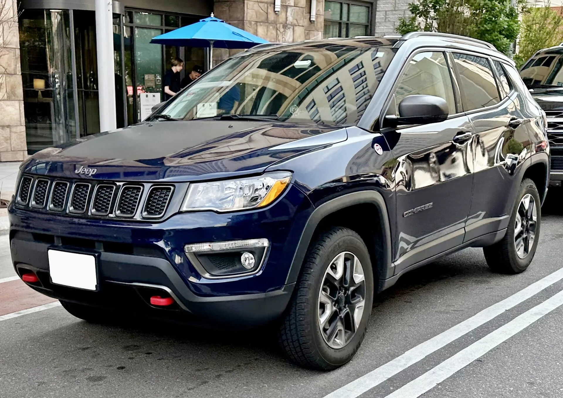 A blue Jeep Compass (MP generation) Trailhawk on a road, the compact SUV this car-camping fit-and-setup guide covers.