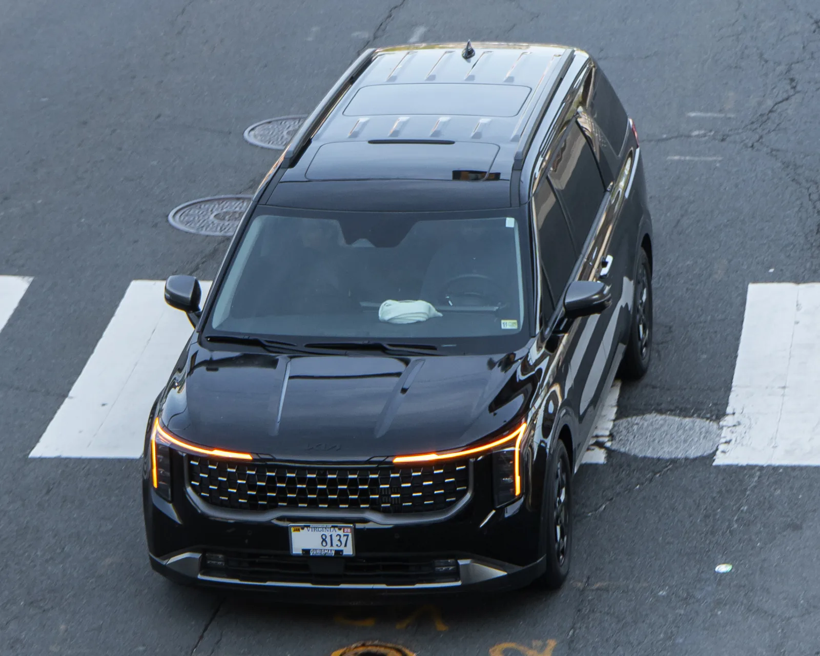 A Kia Carnival seen from above, the minivan whose cargo dimensions for sleeping this guide turns into a bed