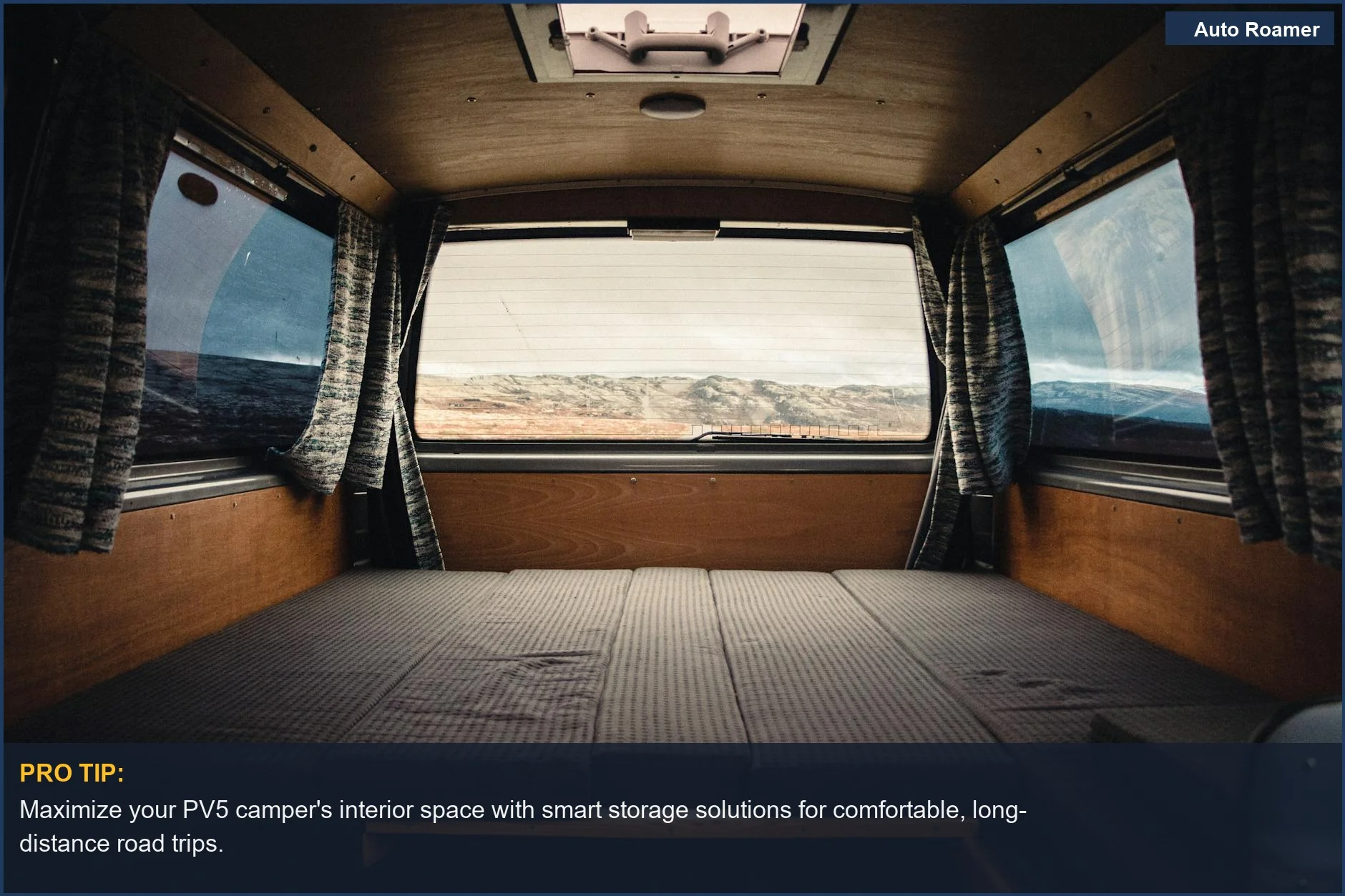Spacious and comfortable interior of a Kia PV5 camper van with a scenic mountain view.