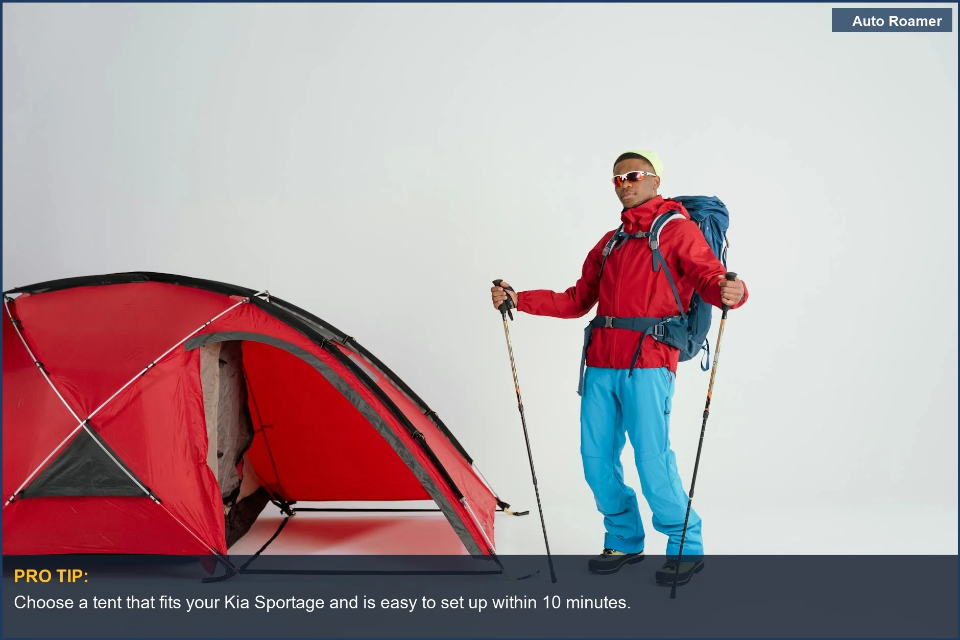 Winter camping gear setup by a red tent next to a Kia Sportage, emphasizing outdoor adventure.