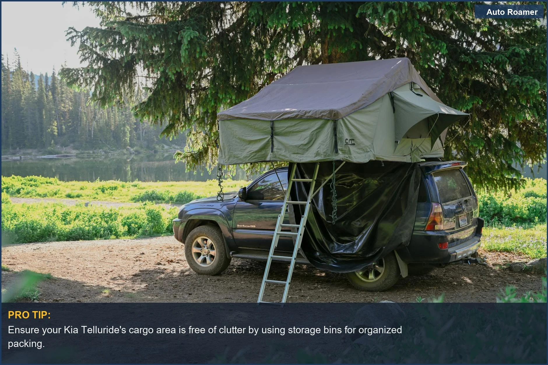 Serene forest campsite with a Kia Telluride parked beside a tranquil lake and rooftop tent.