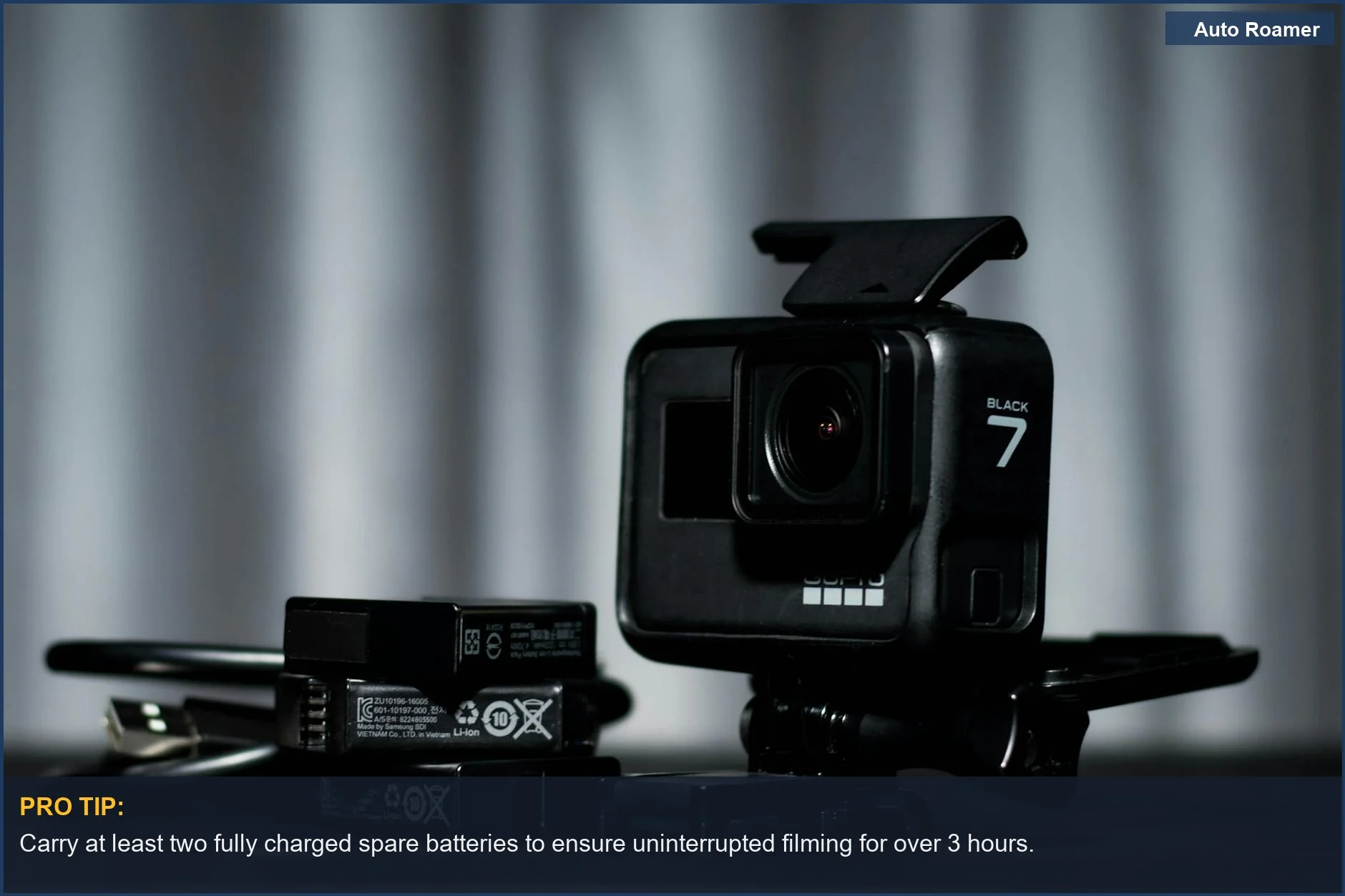 Close-up of black action camera and spare batteries, vital for extending action camera life.