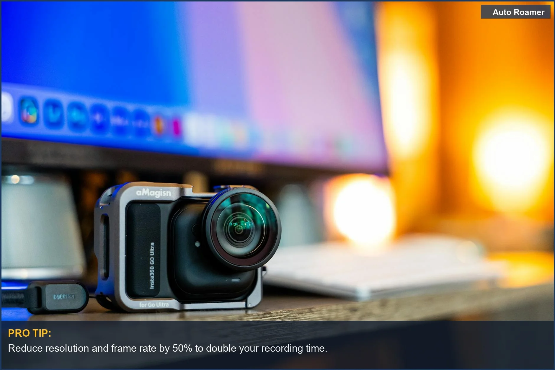 Action camera on a desk near a computer, ready to adjust settings for extended recording time.