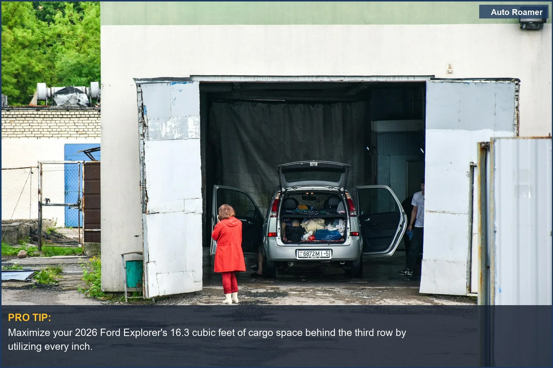 Woman packing 2026 Ford Explorer trunk, preparing for a road trip with smart gear storage.