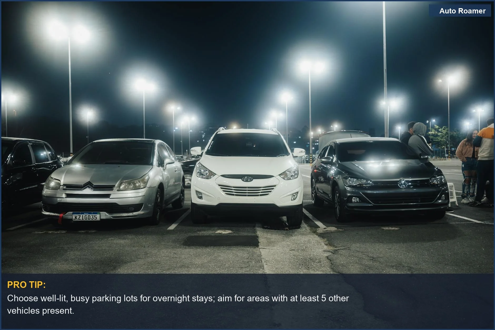 Well-lit night parking lot with cars, highlighting security for car camping privacy after dark.