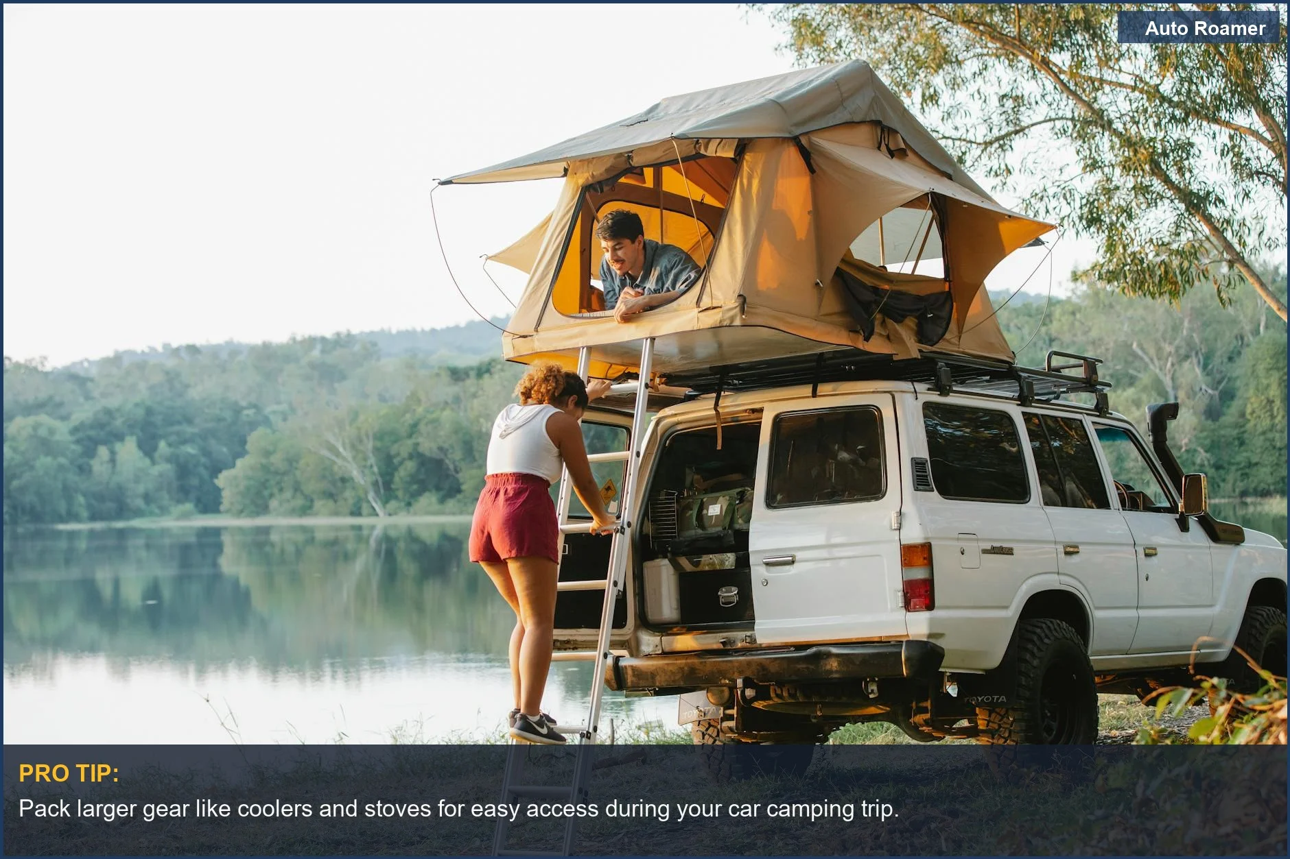 Couple camping by the lake with Mazda CX 30 and rooftop tent, enjoying nature's beauty.