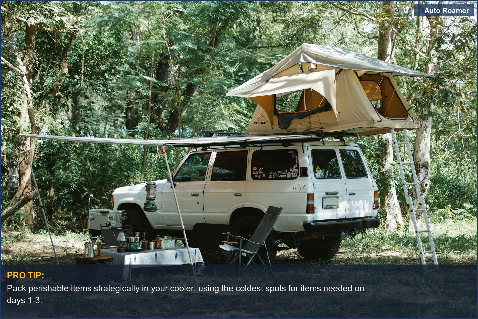 Off-road car with tent on top parked near a picnic setup with food and utensils for extended trip food.