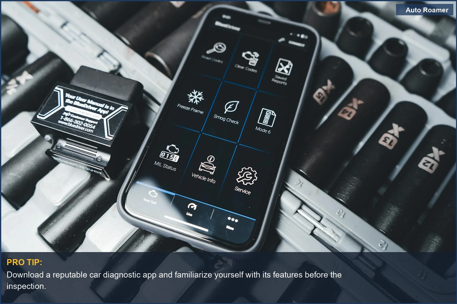 Close-up of smartphone with car diagnostic app and OBD2 scanner for used car buying.