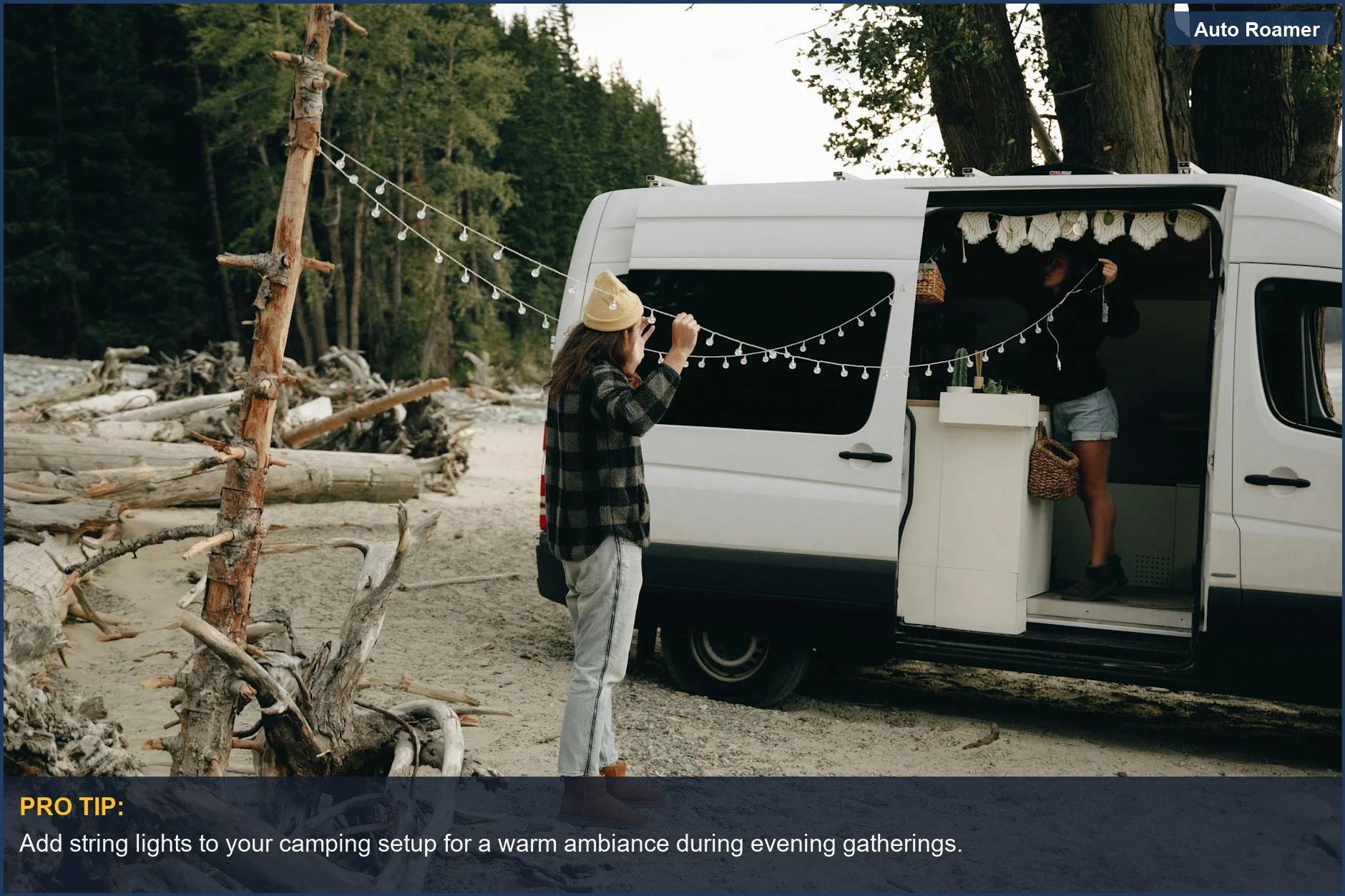 Couple decorating their campervan with string lights for a cozy atmosphere outdoors.
