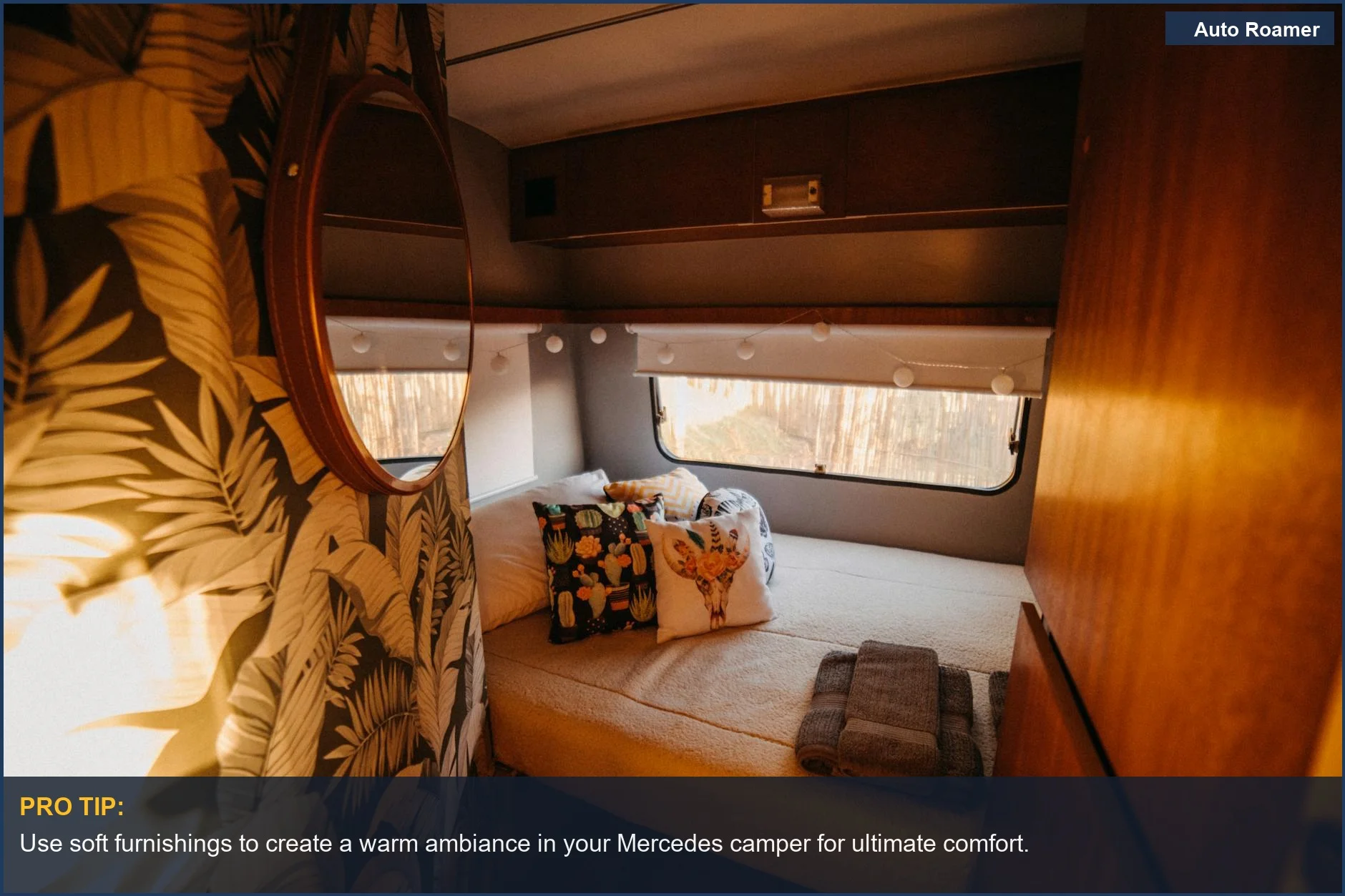 Stylish camper van interior featuring a cozy bed and decorative pillows, inviting for travel.