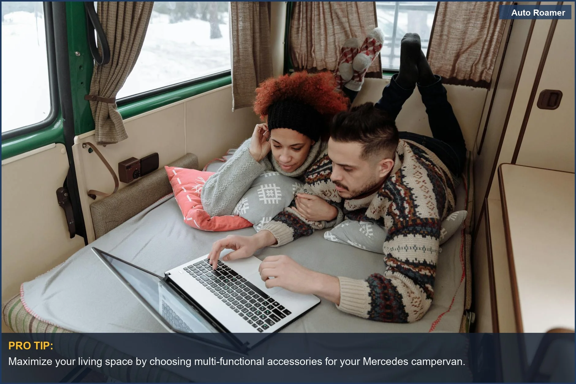 Couple working on laptop in a cozy Mercedes campervan interior, highlighting essential accessories.