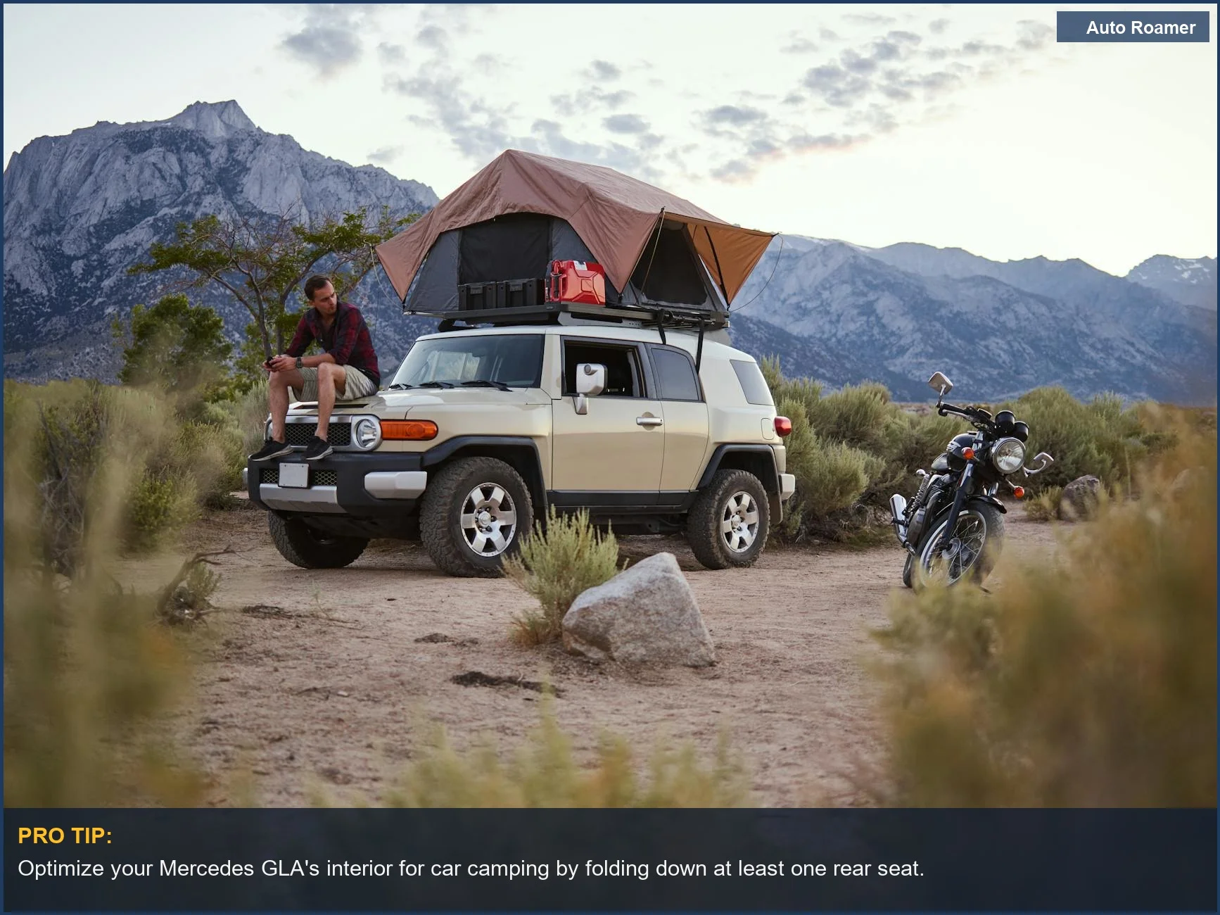 Man relaxing on a Mercedes GLA with rooftop tent, enjoying a scenic mountain view for ultimate car camping.