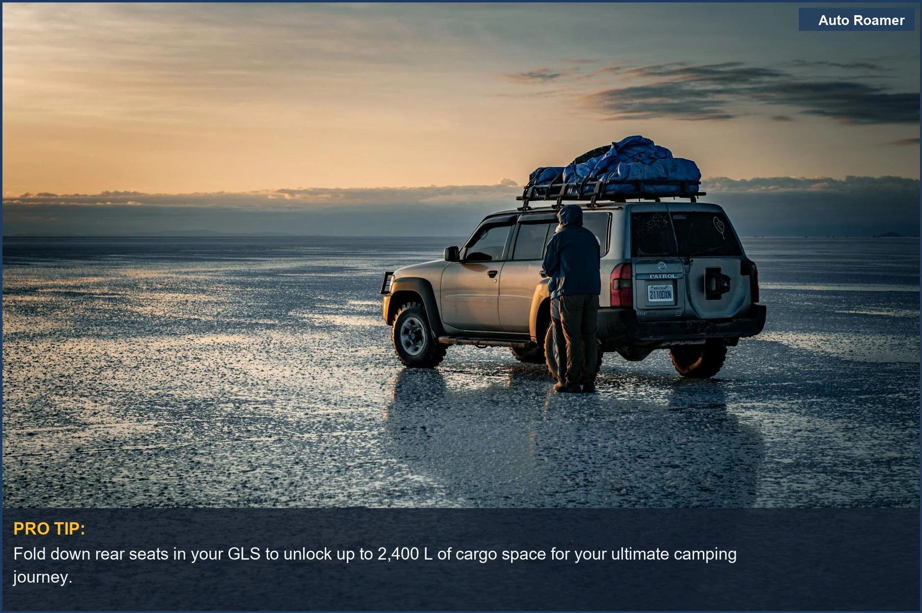 Off-road Mercedes GLS packed for adventure, parked at dawn in a vast, scenic landscape.