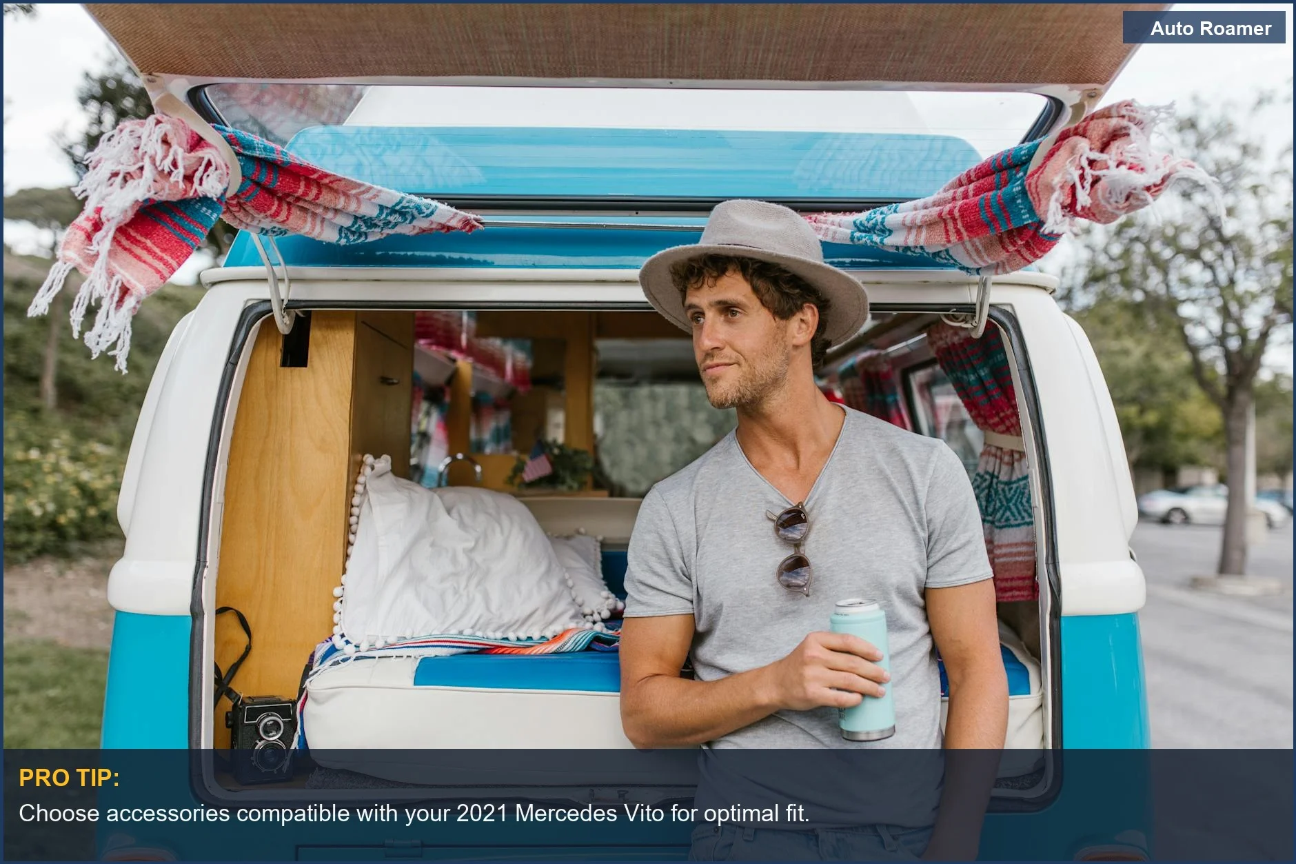 Man relaxing beside a Mercedes Vito campervan with a drink, showcasing travel lifestyle.