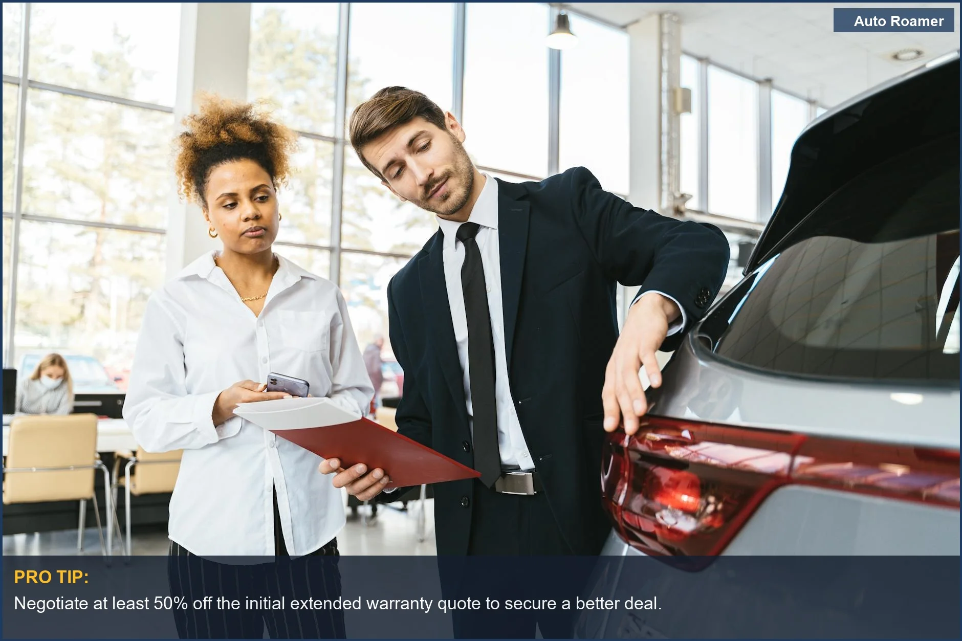 Businessman and customer negotiating extended car warranty price in a modern showroom.