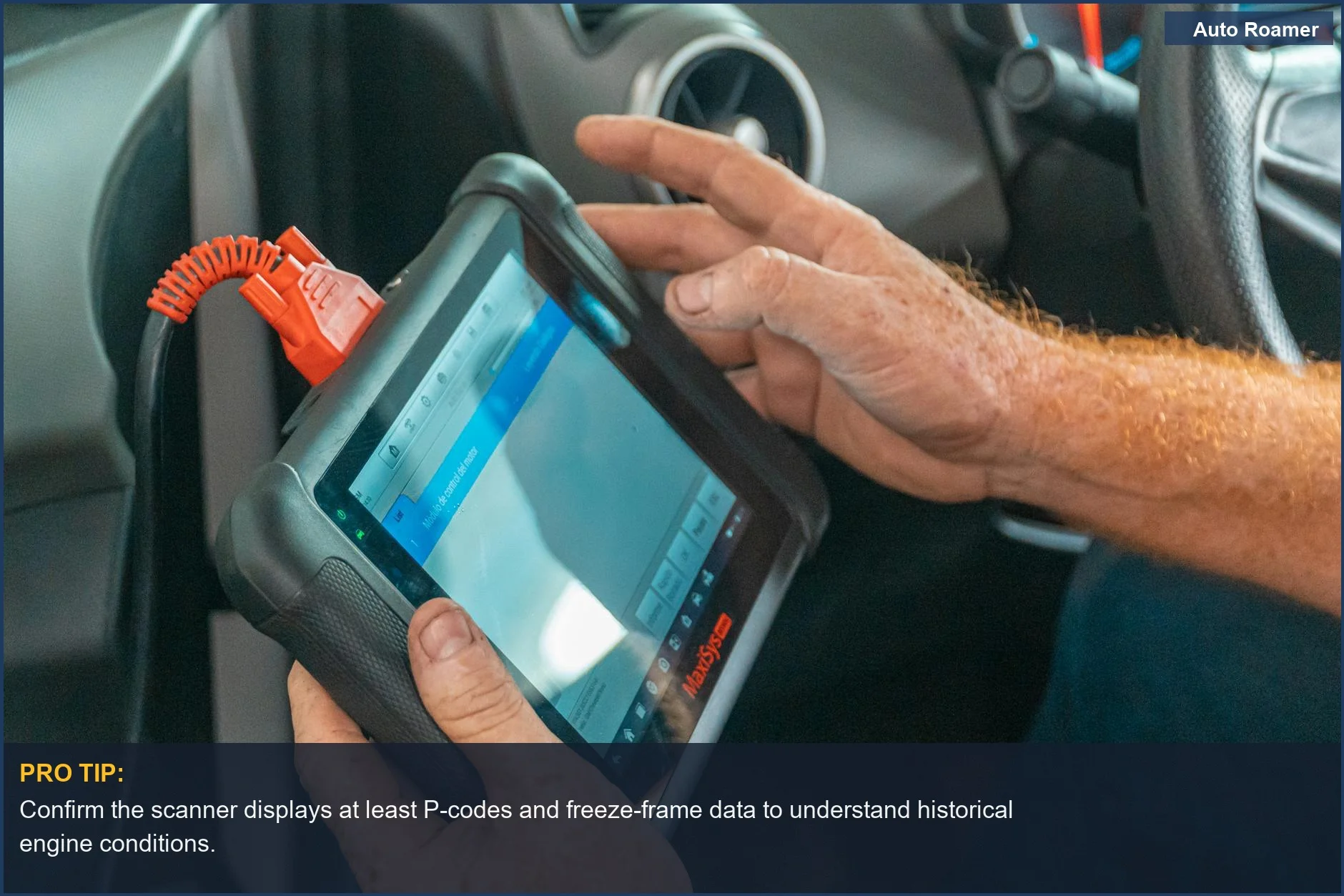 Mechanic analyzing vehicle data on a diagnostic tablet inside a used car.