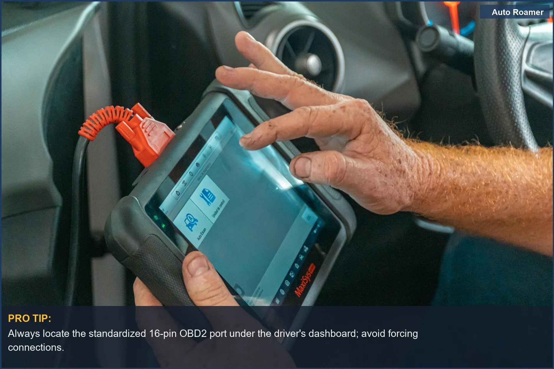 Close view of a mechanic using a diagnostic tool to check for engine problems in a car.