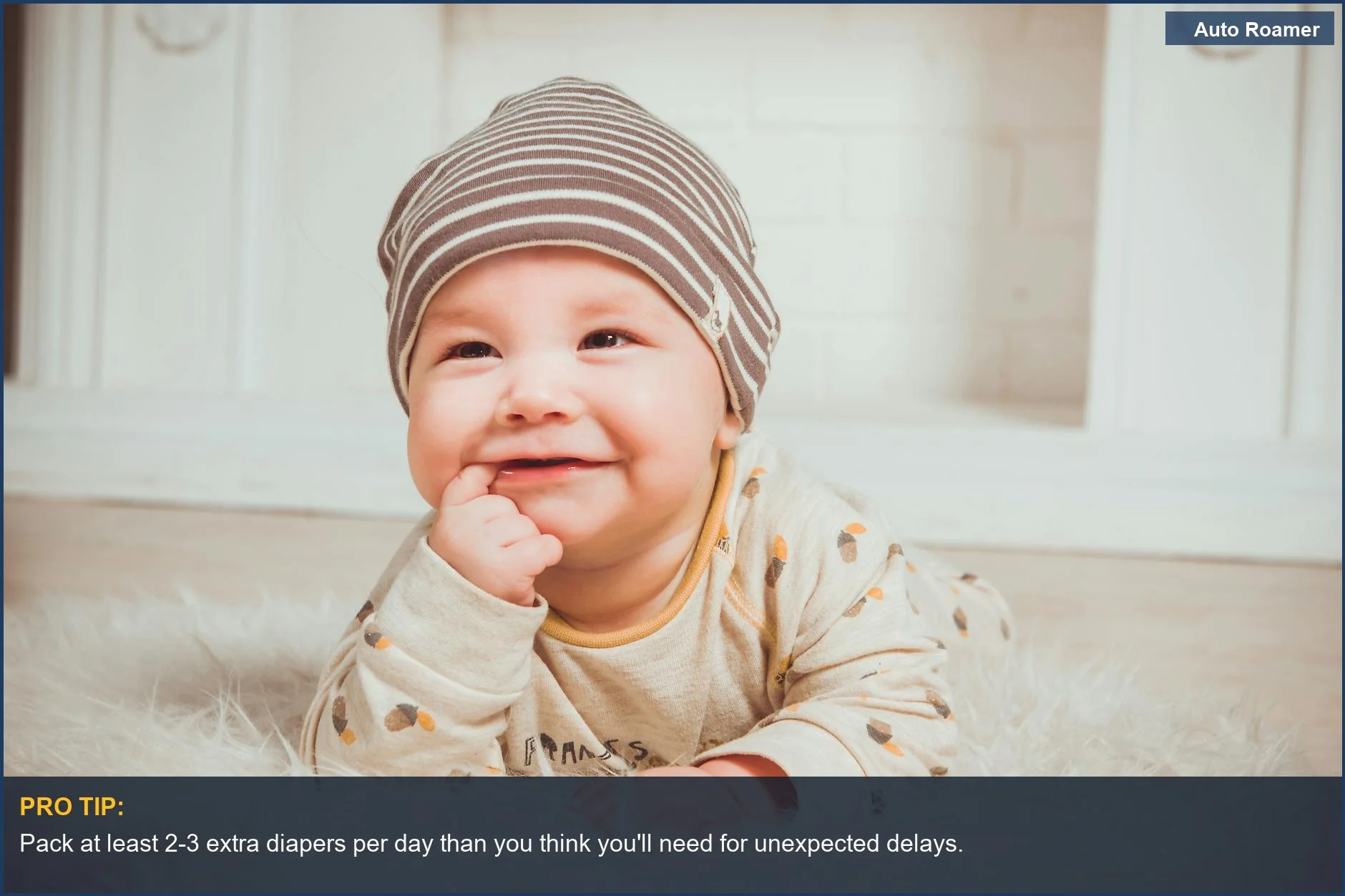 Smiling baby in striped beanie ready for travel, a key part of your baby travel checklist.