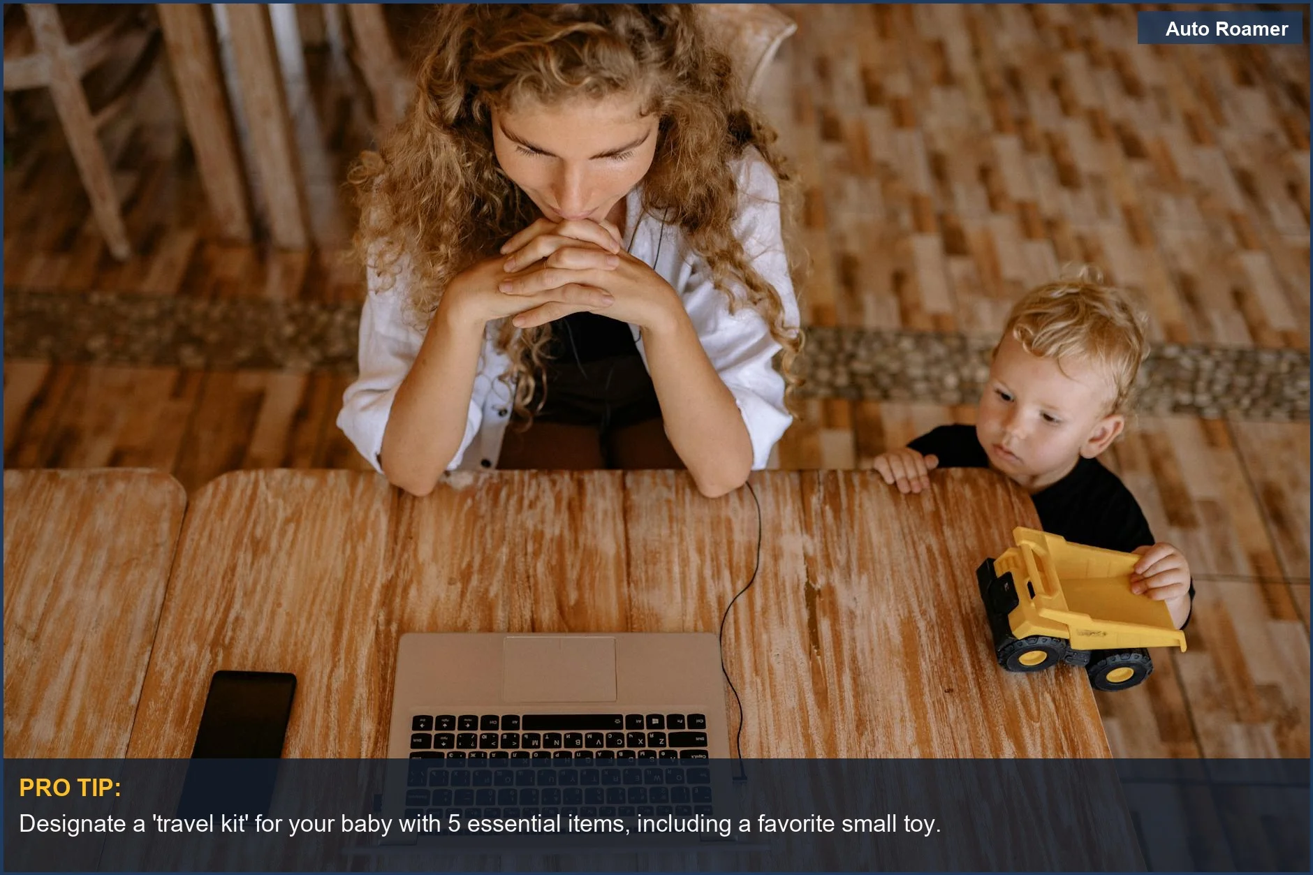 Woman working on laptop with child playing nearby, illustrating newborn travel essentials for parents.