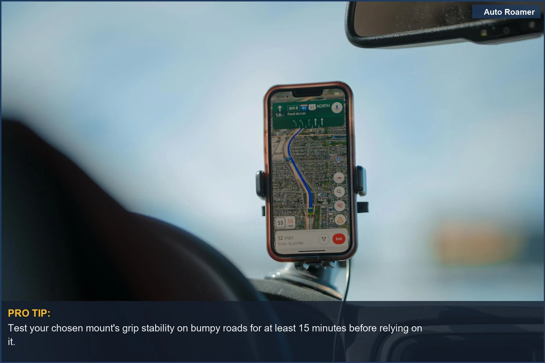 Smartphone with GPS navigation app displayed, mounted on a car dashboard during a scenic road trip.