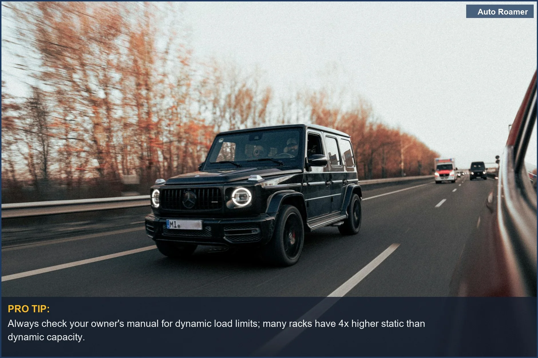 Black luxury SUV driving on a German highway in autumn, demonstrating roof rack load limits for securing cargo.
