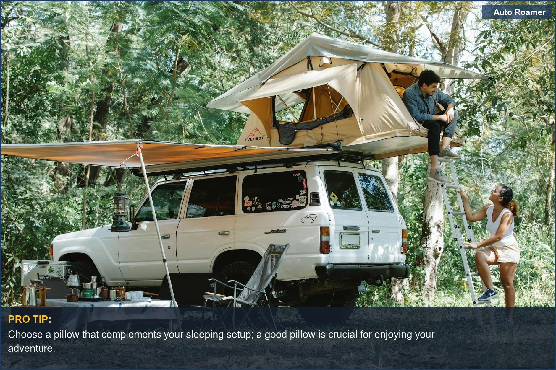 Couple enjoying a scenic forest campsite with their rooftop tent setup.